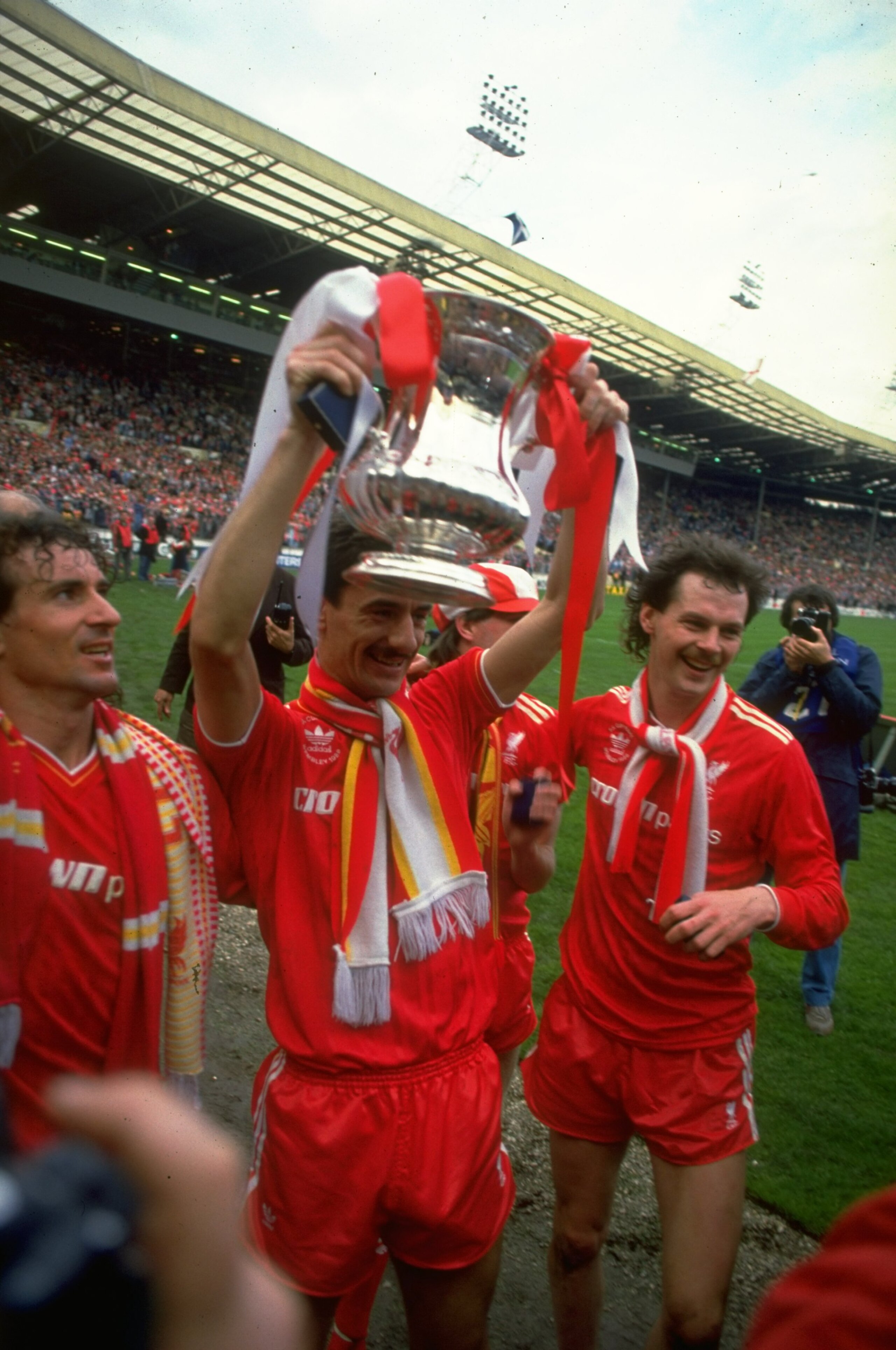 1986: Craig Johnston (left), Ian Rush (centre) and Kevin MacDonald (right) all of Liverpool pose with the trophy after their victory in the the FA Cup final against Everton at Wembley Stadium in London. Liverpool won the match 3-1. \ Mandatory Credit: Da 1986: Craig Johnston (left), Ian Rush (centre) and Kevin MacDonald (right) all of Liverpool pose with the trophy after their victory in the the FA Cup final against Everton at Wembley Stadium in London. Liverpool won the match 3-1. \ Mandatory Credit: Da