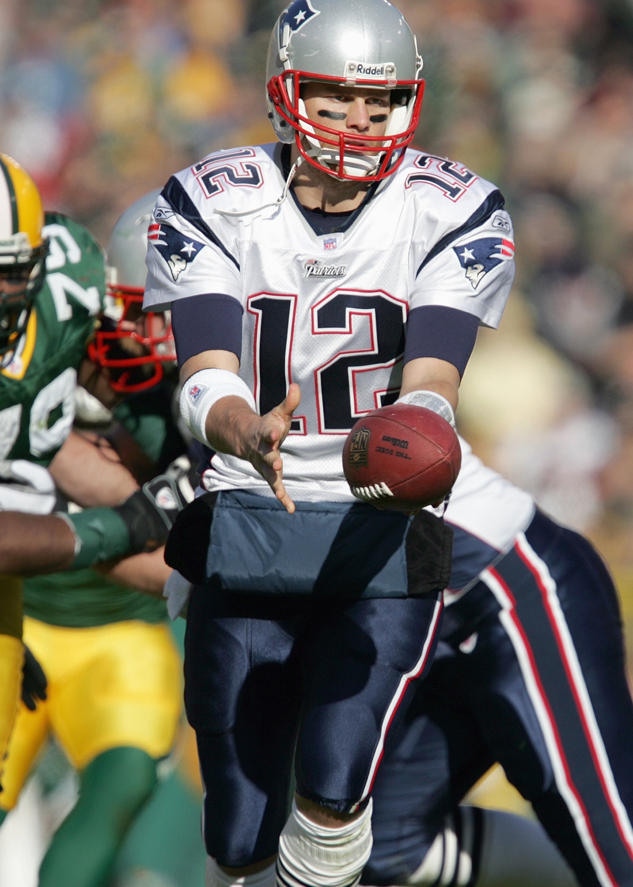 GREEN BAY, WI - NOVEMBER 19: Tom Brady #12 of the New England Patriots hands off the ball during the game against the Green Bay Packers on November 19, 2006 at Lambeau Field in Green Bay, Wisconsin. The Patriots defeated the Packers 35-0. (Photo by Jonath
