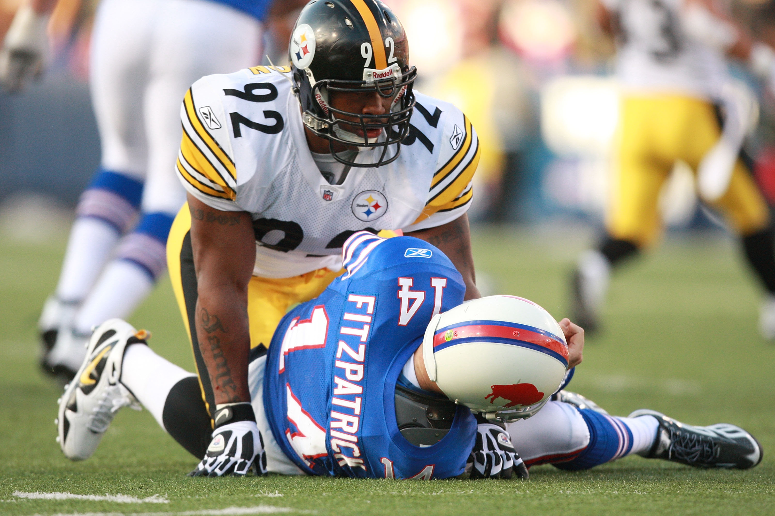 ORCHARD PARK, NY - NOVEMBER 28:  James Harrison #92 of the Pittsburgh Steelers rises after hitting Ryan Fitzpatrick of the Buffalo Bills during their game at Ralph Wilson Stadium on November 28, 2010 in Orchard Park, New York.  Harrison was flagged for ro