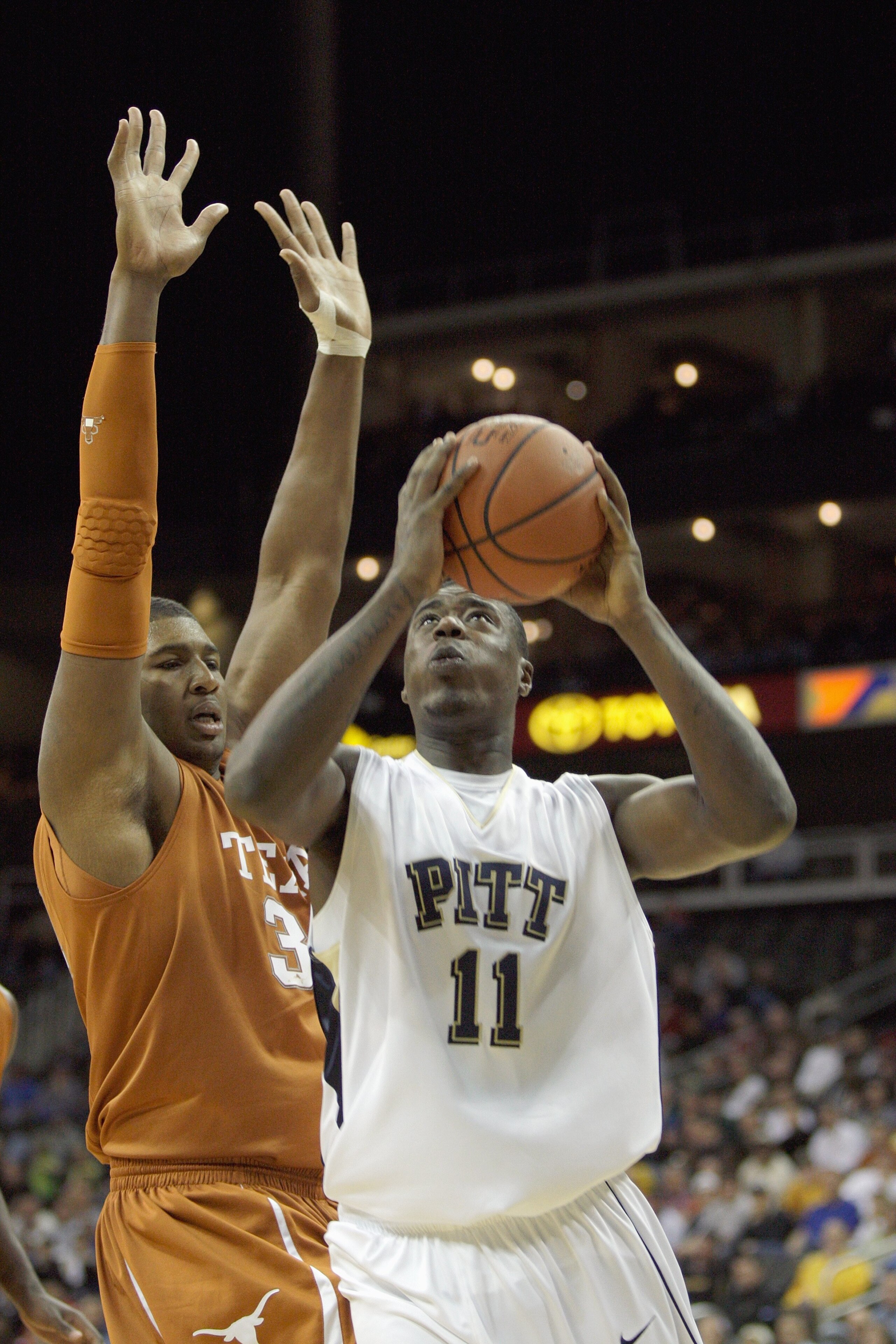 KANSAS CITY,MO - NOVEMBER 24:  Dante Taylor #11 of the Pittsburgh Panthers puts a shot up against Dexter Pittman #34 of the Texas Longhorns during the CBE Classic championship game on November 24, 2009 at Sprint Center in Kansas City, Missouri. (Photo by: