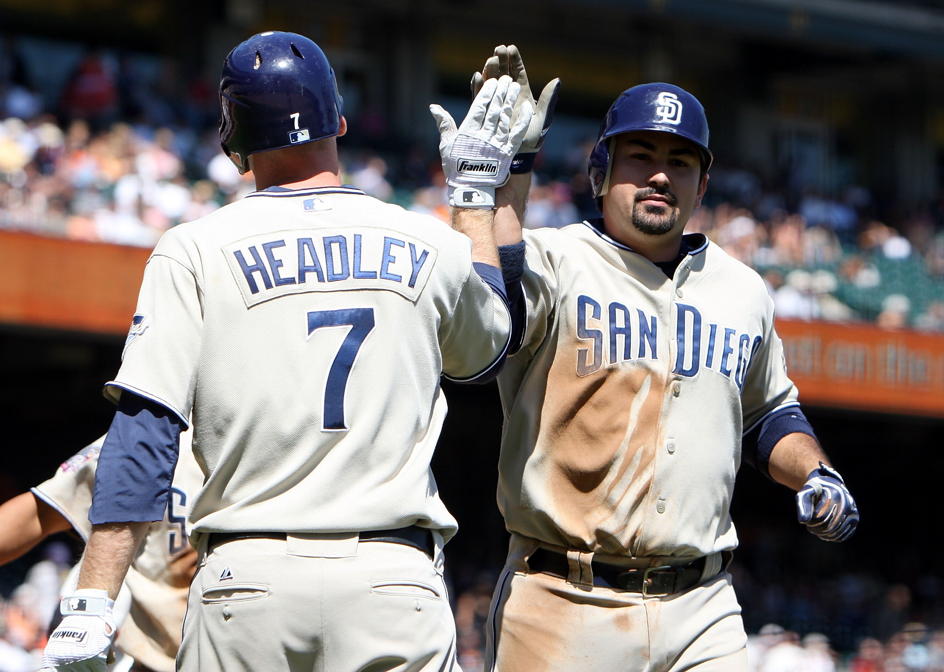 SAN FRANCISCO - SEPTEMBER 09:  Adrian Gonzalez #23 of the San Diego Padres celebrates with teammate Chase Headley #7 after hitting a home run in the third inning against the San Francisco Giants during a Major League Baseball game at AT&T Park on Septembe