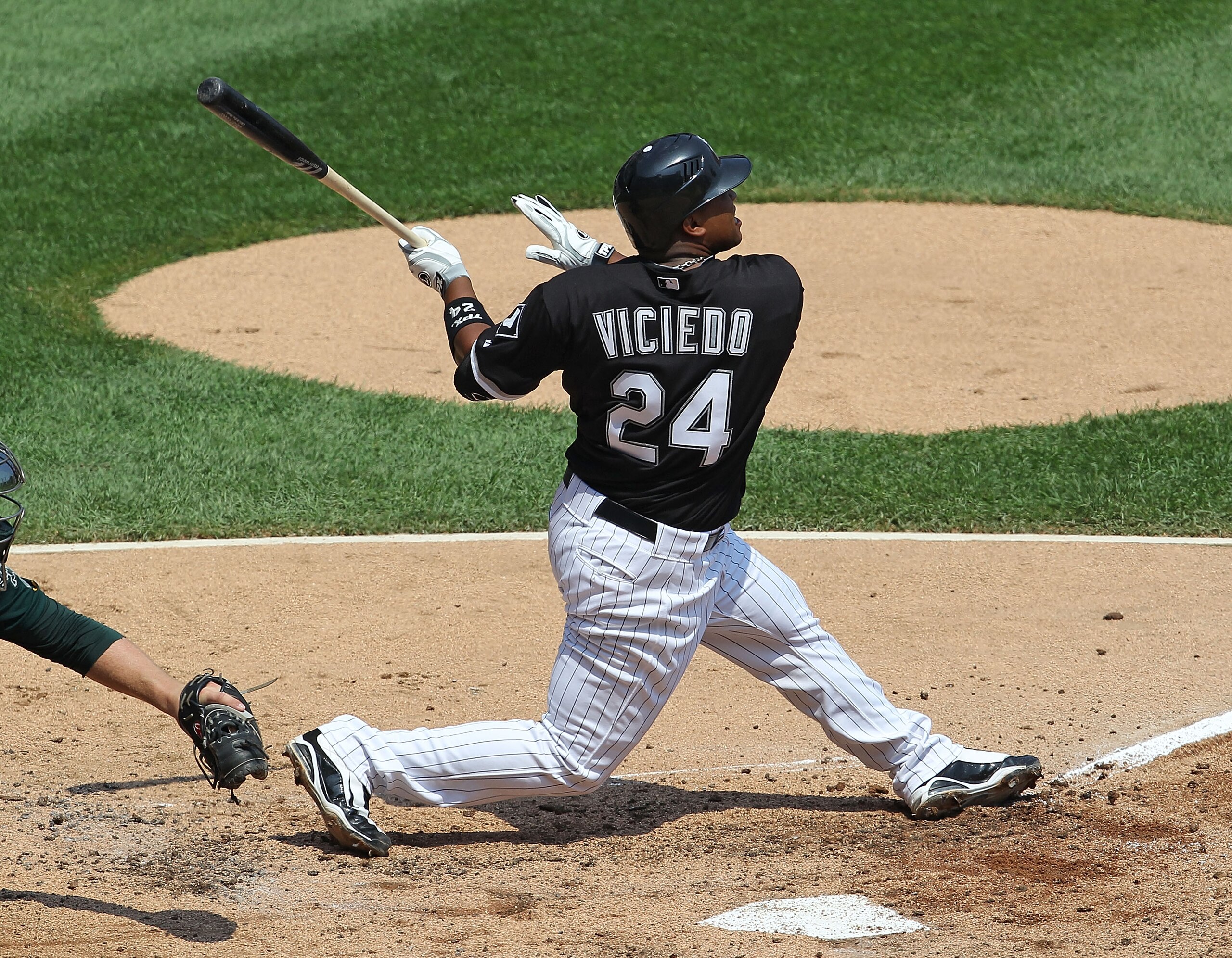 CHICAGO - AUGUST 01: Dayan Viciedo #24 of the Chicago White Sox hits the ball against the Oakland Athletics at U.S. Cellular Field on August 1, 2010 in Chicago, Illinois. The White Sox defeated the Athletics 4-1. (Photo by Jonathan Daniel/Getty Images)