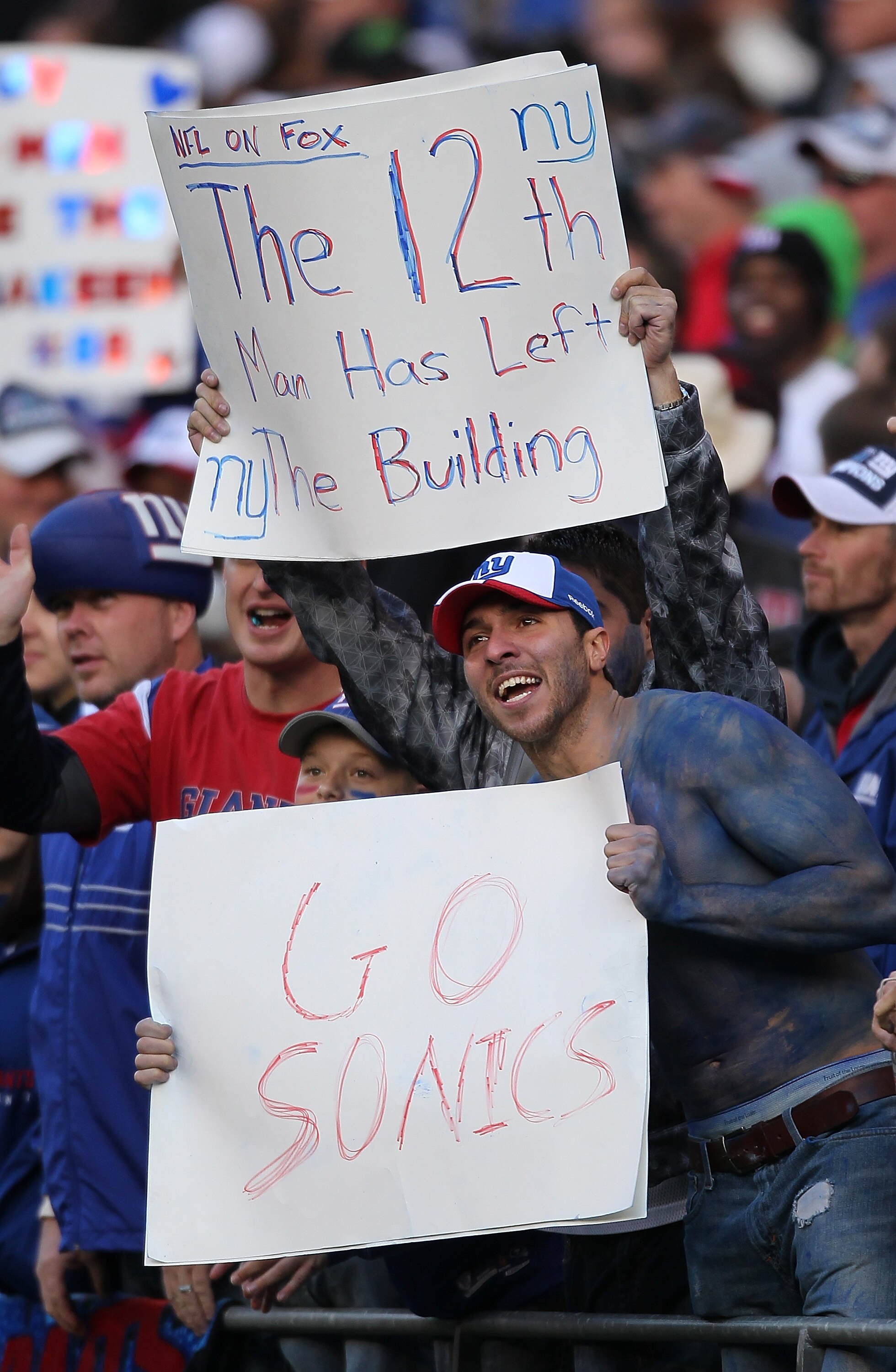 SEATTLE - NOVEMBER 07:  Fans of the New York Giants hold signs during the game against the Seattle Seahawks at Qwest Field on November 7, 2010 in Seattle, Washington. The Giants defeated the Seahawks 41-7. (Photo by Otto Greule Jr/Getty Images)