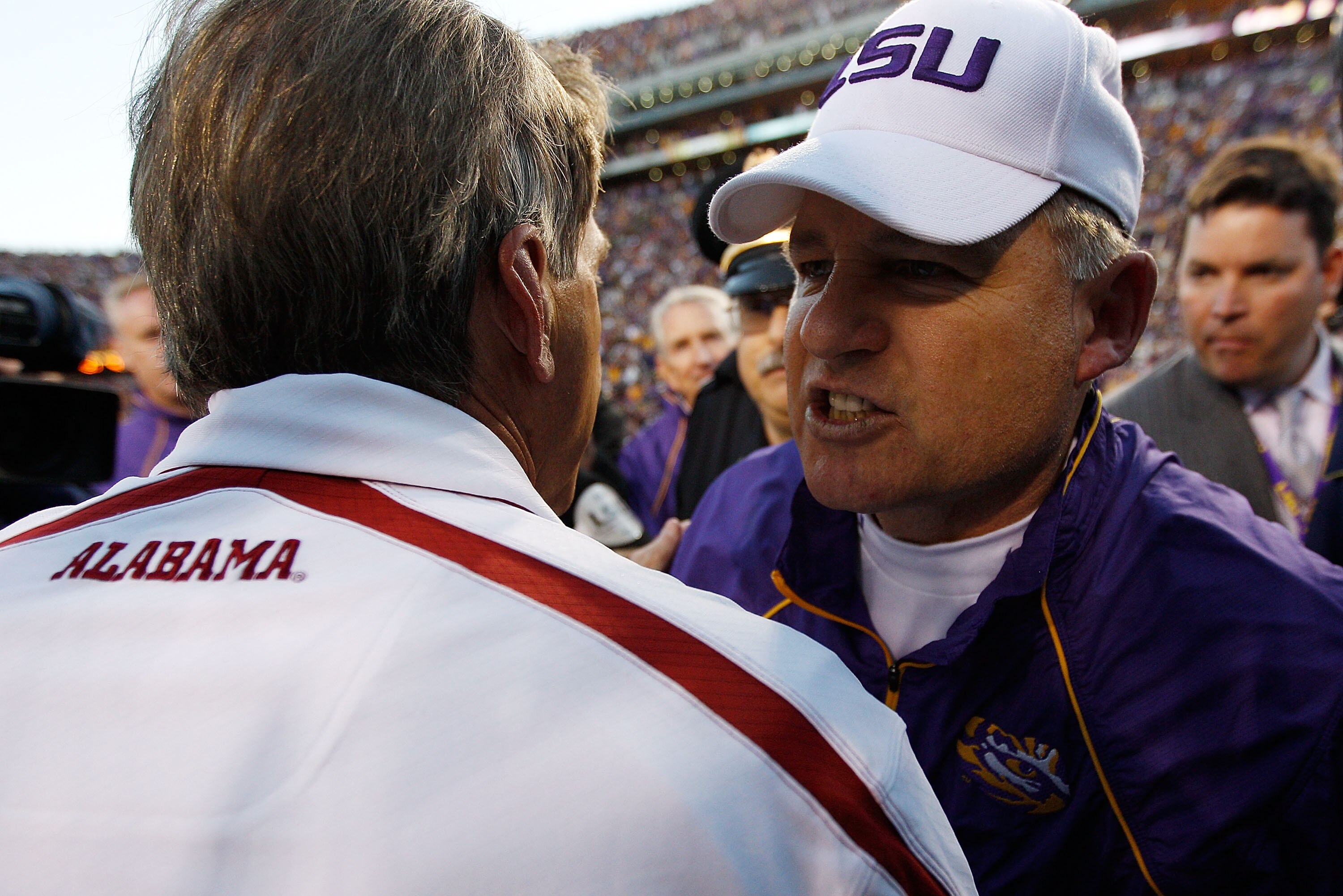 BATON ROUGE, LA - NOVEMBER 06:  Head coach Les Miles of the Louisiana State University Tigers is congratulated by Nick Saban of the Alabama Crimson Tide at Tiger Stadium on November 6, 2010 in Baton Rouge, Louisiana. The Tigers defeated the Crimson Tide 2