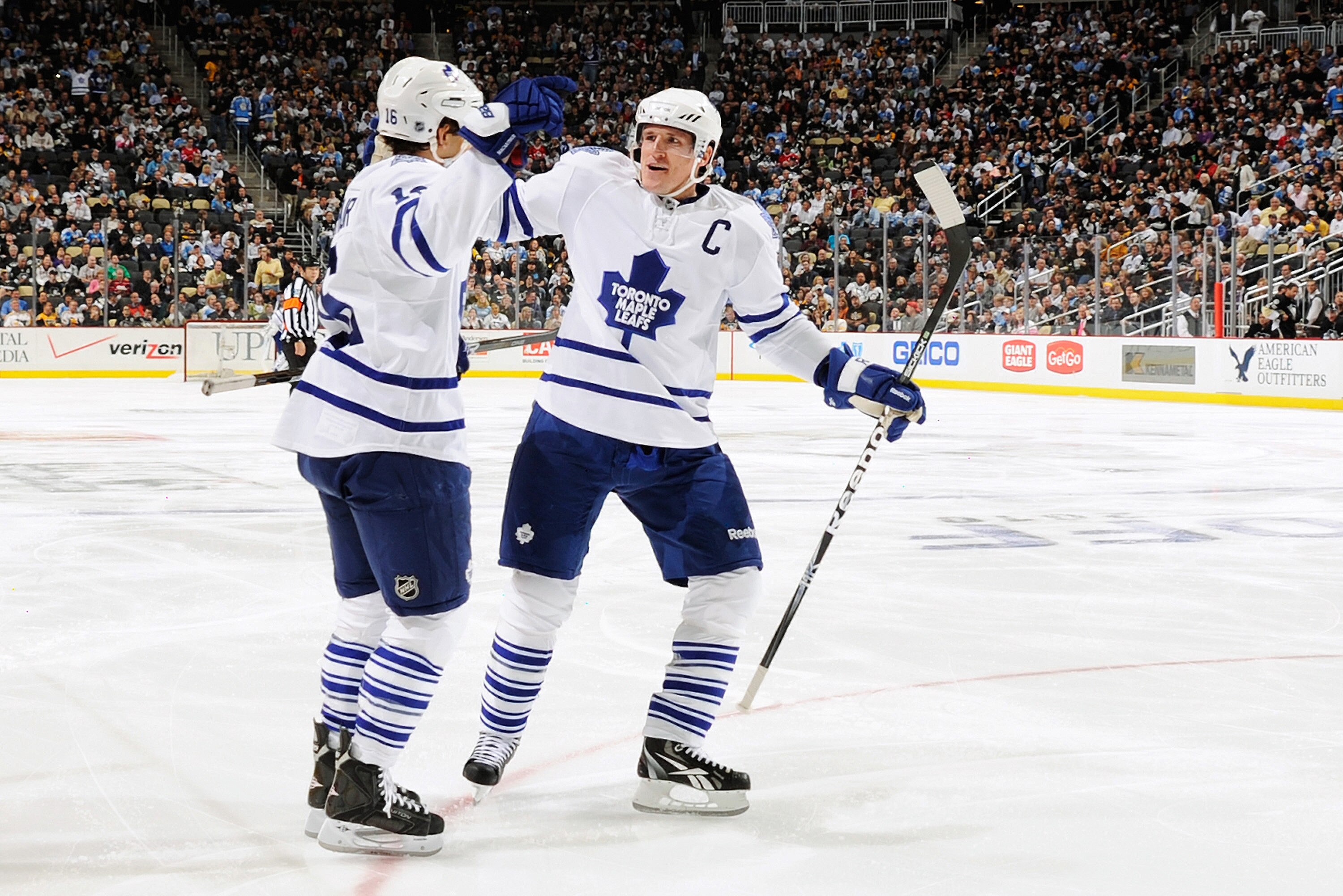PITTSBURGH - OCTOBER 13:  Dion Phaneuf #3 of the Toronto Maple Leafs celebrates with teammate Clarke MacArthur #16 of the Toronto Maple Leafs after MacArthur's second period power play goal against the Pittsburgh Penguins on October 13, 2010 at Consol Ene