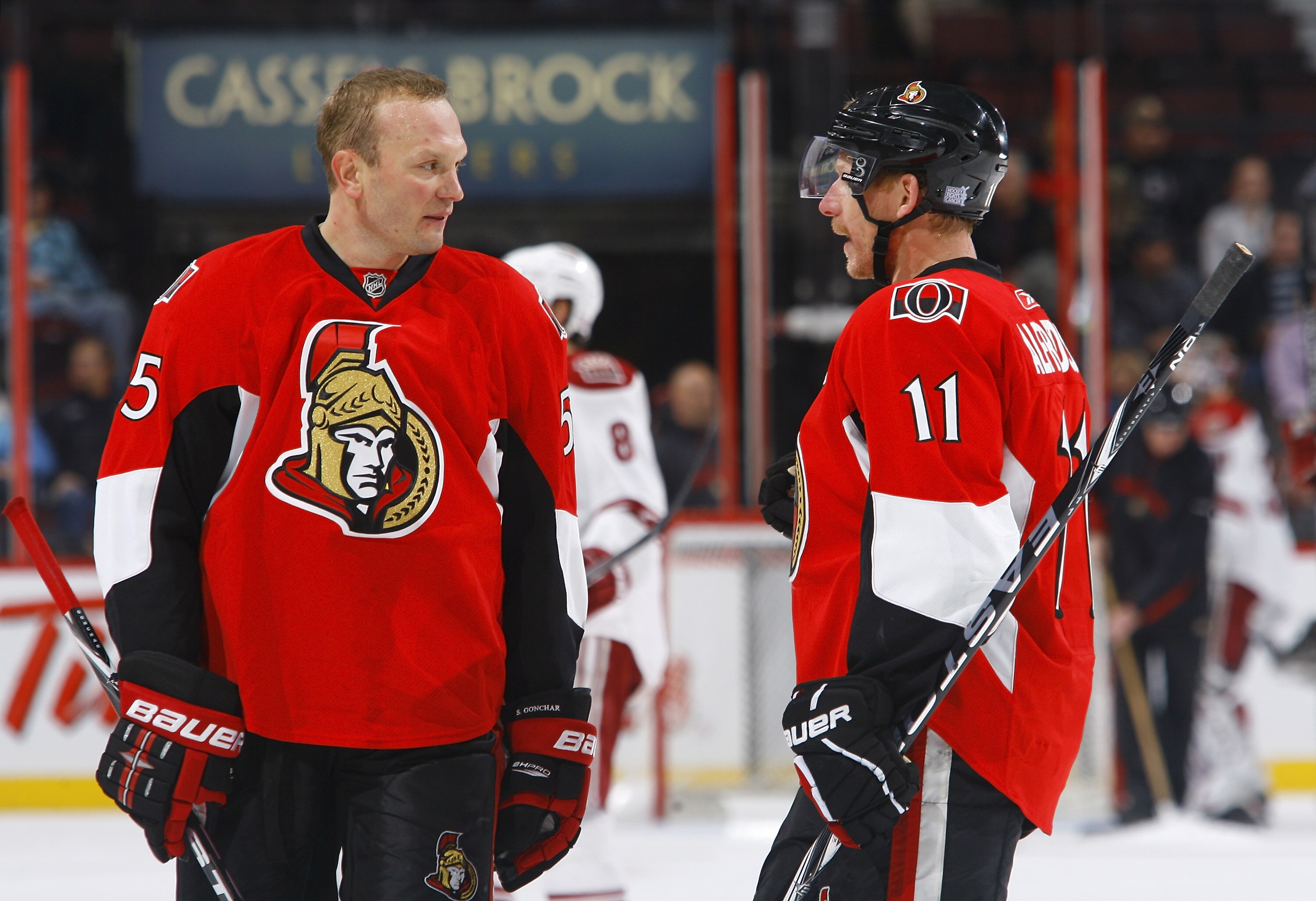 OTTAWA, ON - OCTOBER 26:  In his 1000th NHL regular season game Sergei Gonchar #55 of the Ottawa Senators discusses strategy with teammate Daniel Alfredsson #11 during a game against the Phoenix Coyotes at Scotiabank Place on October 26, 2010 in Ottawa, O