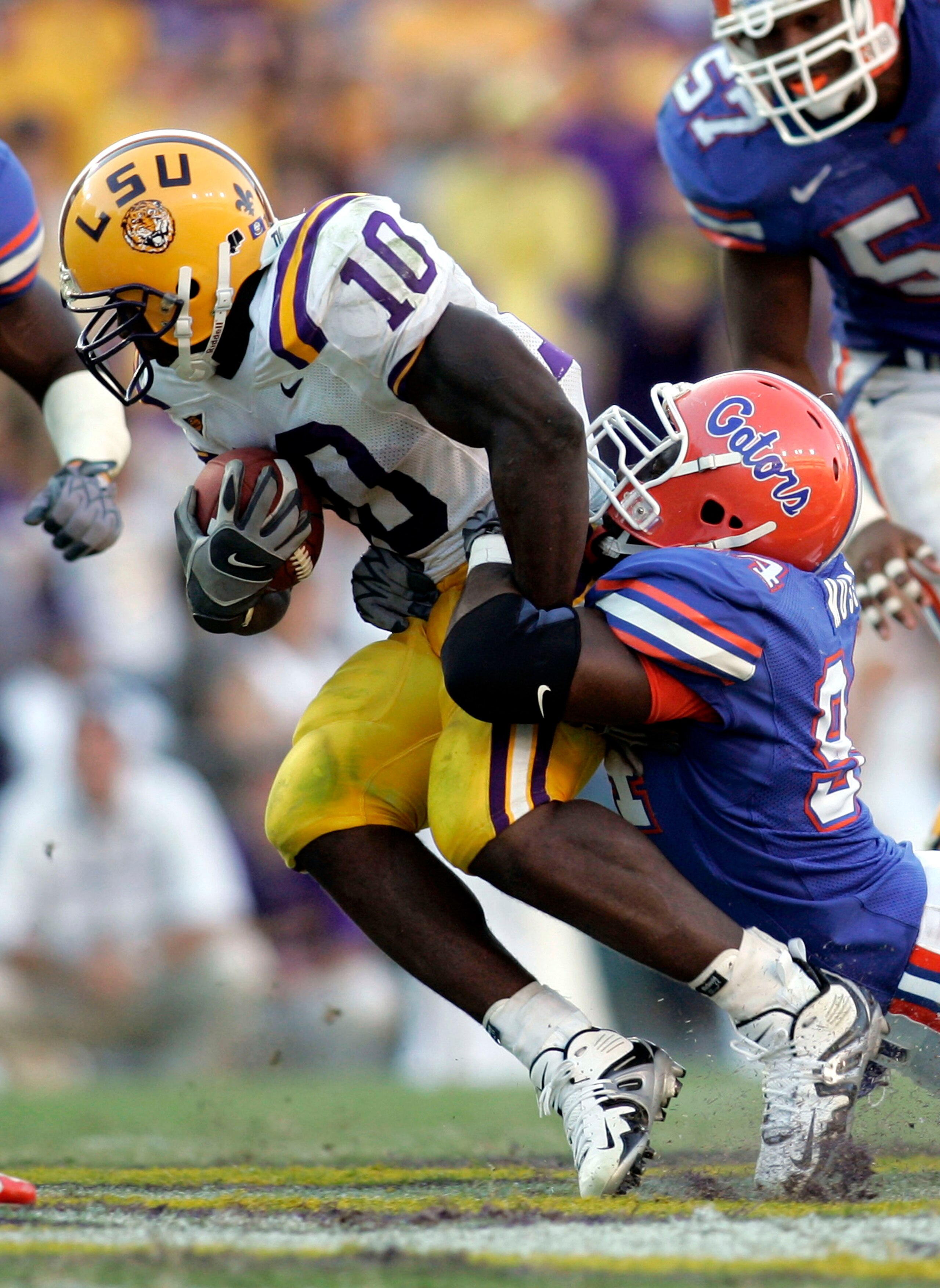BATON ROUGE, LA - OCTOBER 15: Joseph Addai #10 of Louisiana State University is tackled by Jarvis Moss #94 of the University of Florida at Tiger Stadium in Baton Rouge, Louisiana on October 15, 2005. LSU defeated the University of Florida 21-17. (Phot BATON ROUGE, LA - OCTOBER 15: Joseph Addai #10 of Louisiana State University is tackled by Jarvis Moss #94 of the University of Florida at Tiger Stadium in Baton Rouge, Louisiana on October 15, 2005. LSU defeated the University of Florida 21-17. (Phot