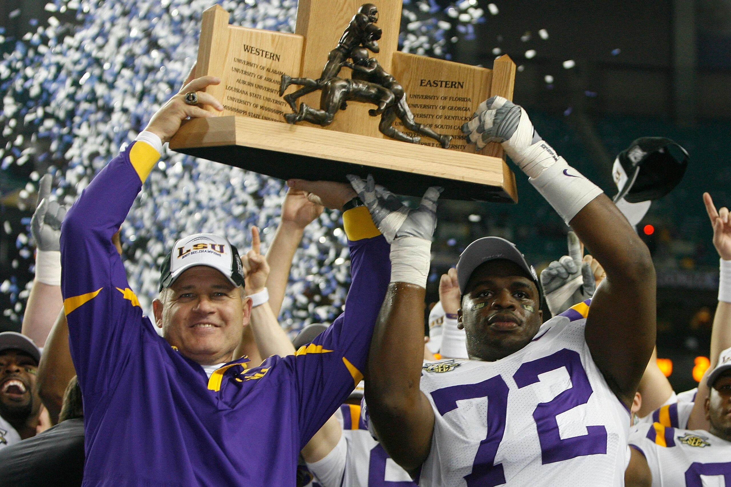 ATLANTA - DECEMBER 01: Head coach Les Miles and Glenn Dorsey #72 of the Louisiana State University Tigers celebrate with the SEC trophy after defeating the University of Tennessee Volunteers 21-14 in the SEC Championship game on December 1, 2007 at the ATLANTA - DECEMBER 01: Head coach Les Miles and Glenn Dorsey #72 of the Louisiana State University Tigers celebrate with the SEC trophy after defeating the University of Tennessee Volunteers 21-14 in the SEC Championship game on December 1, 2007 at the
