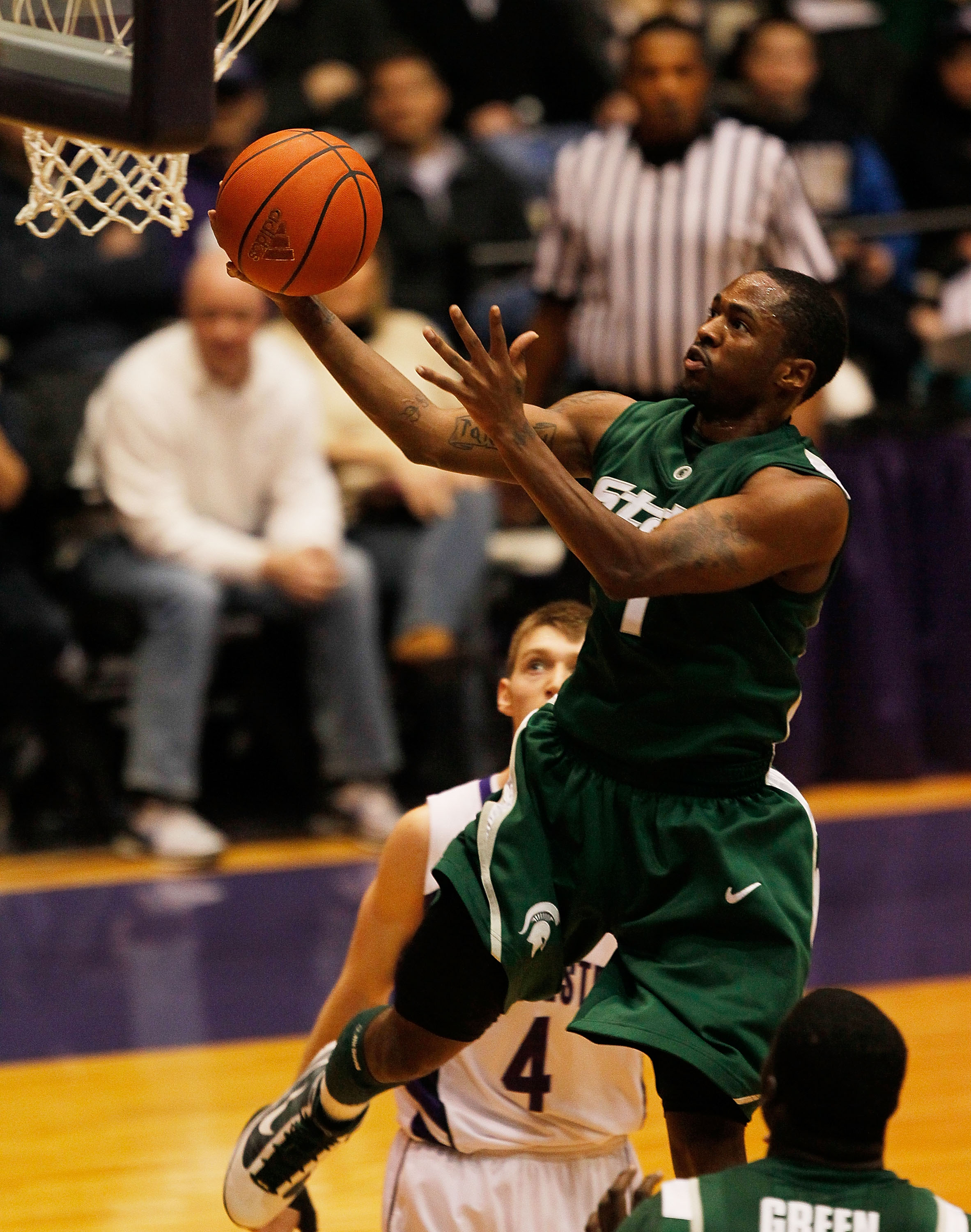 EVANSTON, IL - JANUARY 02: Kalin Lucas #1 of the Michigan State Spartans drives to the basket past Alex Marcotullio #4 of the Northwestern Wildcats on January 2, 2010 at Welsh-Ryan Arena in Evanston, Illinois. Michigan State defeated Northwestern 91-70.