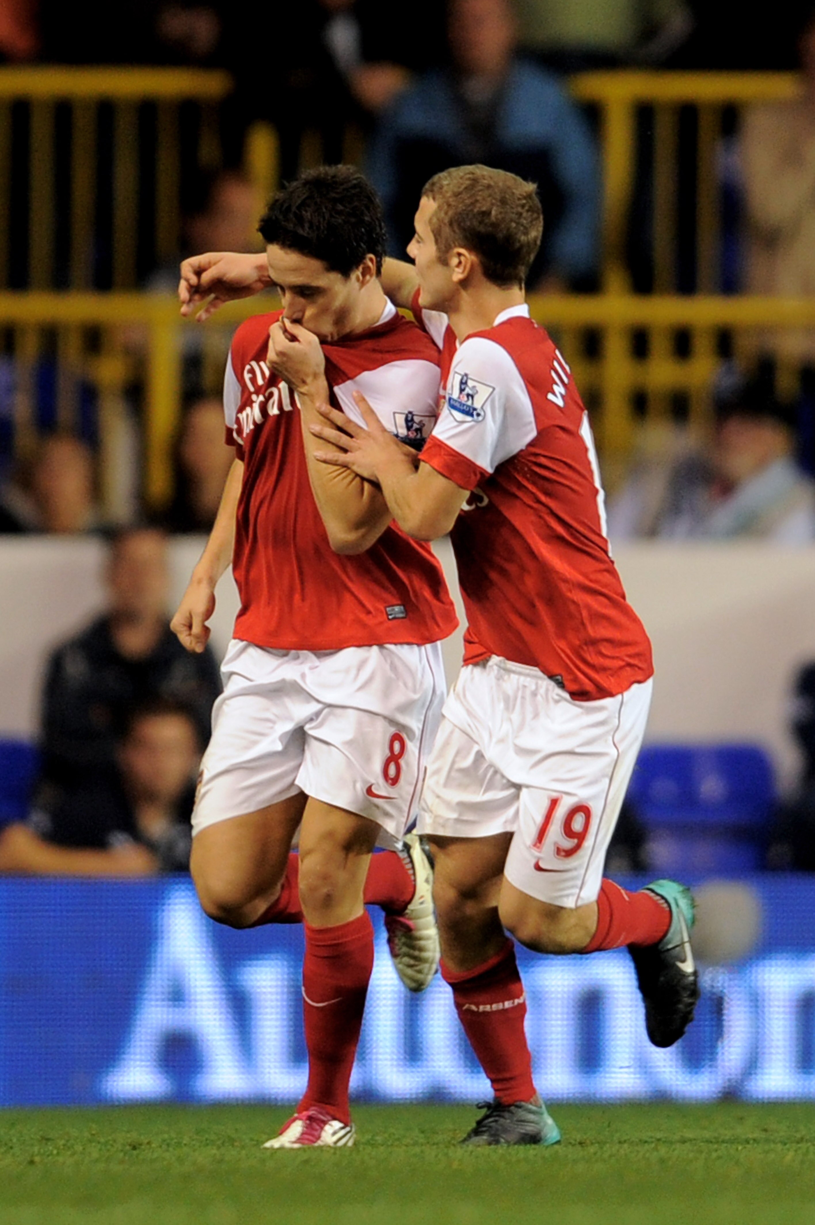 LONDON, ENGLAND - SEPTEMBER 21:  Samir Nasri (L) of Arsenal celebrates with teammate Jack Wilshere after scoring his team's second goal from the penalty spot during the Carling Cup third round match between Tottenham Hotspur and Arsenal at White Hart Lane