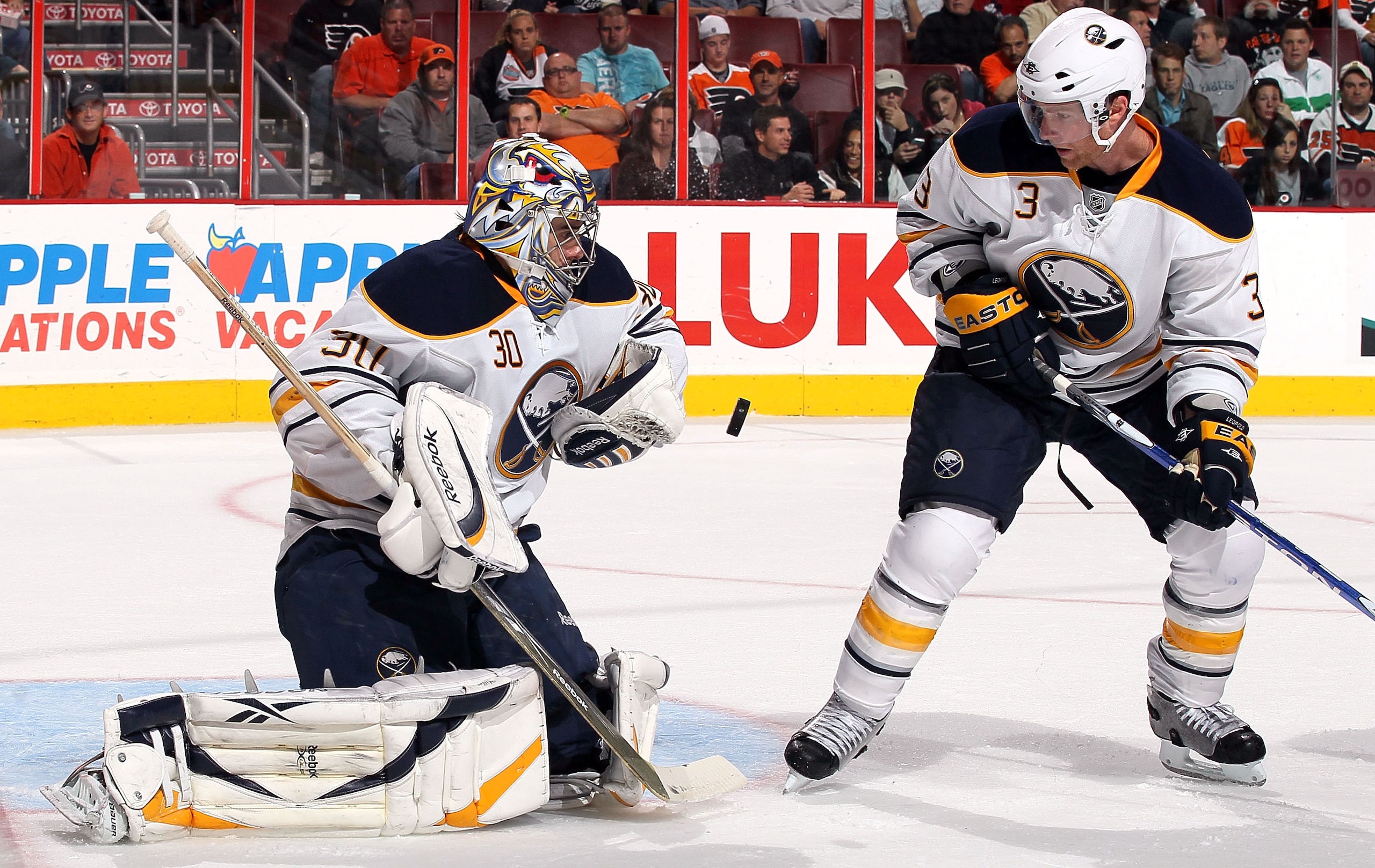 PHILADELPHIA - OCTOBER 26:  Ryan Miller #30 of the Buffalo Sabres makes a save against the Philadelphia Flyers as teammate Jordan Leopold #3 looks on on October 26, 2010 at Wells Fargo Center in Philadelphia, Pennsylvania.  (Photo by Jim McIsaac/Getty Ima