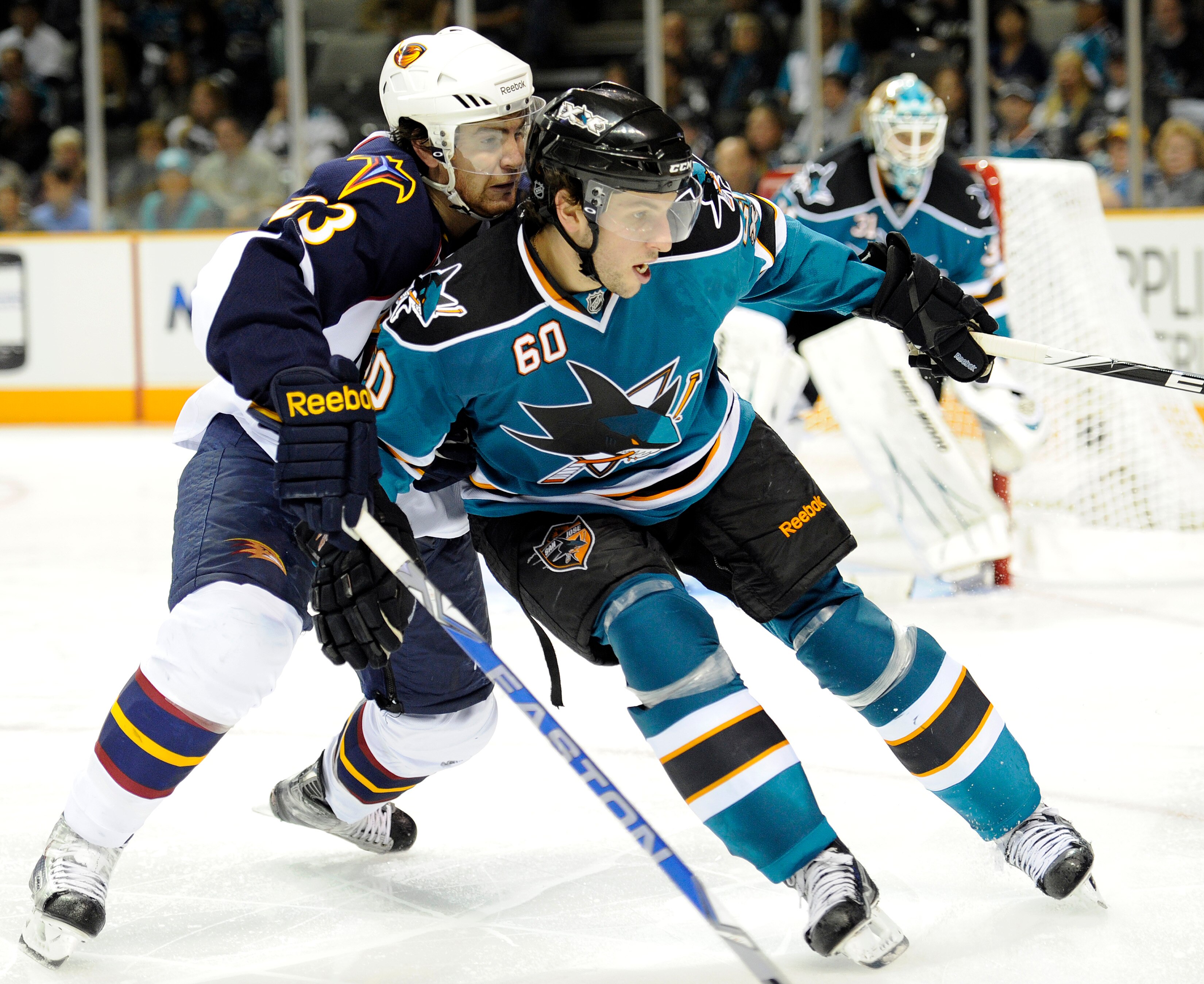 SAN JOSE, CA - OCTOBER 16: Jim Slater #23 of the Atlanta Thrashers checks Jason Demers #60 of the San Jose Sharks during an NHL Hockey game at the HP Pavilion October 16, 2010 in San Jose, California. The Thrashers won the game 4-2. (Photo by Thearon W. H