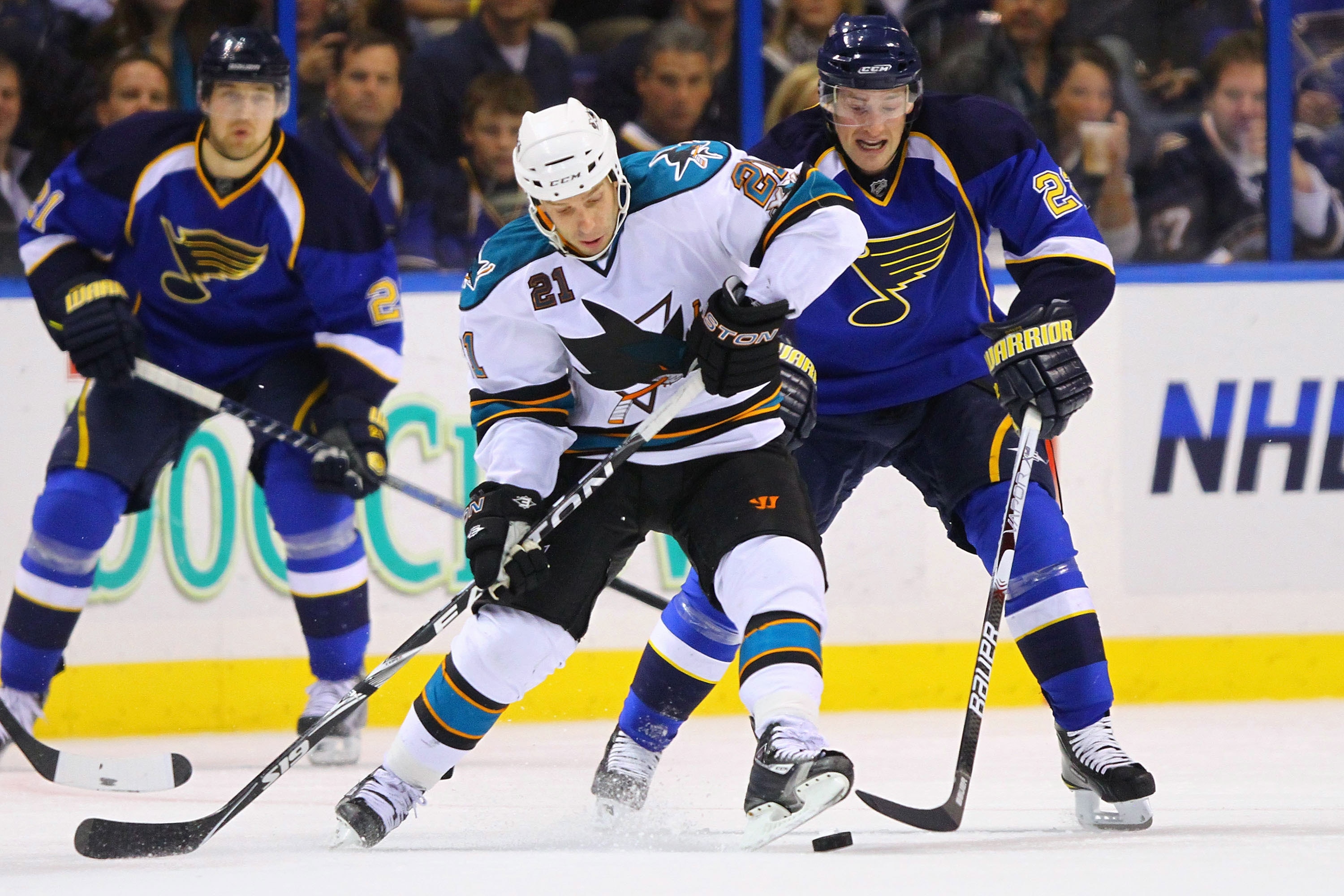 ST. LOUIS - NOVEMBER 4: Scott Nichol #21 of the San Jose Sharks controls the puck against Brad Boyes #22 of the St. Louis Blues at the Scottrade Center on November 4, 2010 in St. Louis, Missouri.  The Blues beat the Sharks 2-1.  (Photo by Dilip Vishwanat/
