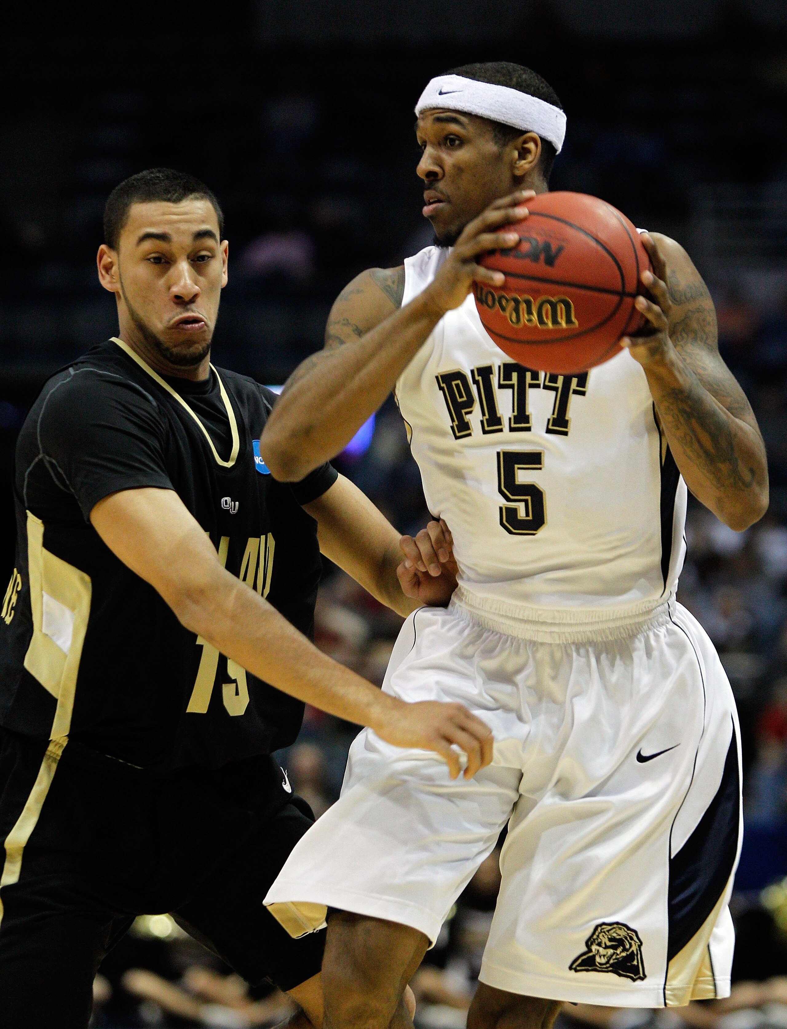 MILWAUKEE - MARCH 19:  Gilbert Brown #5 of the Pittsburgh Panthers with the ball against Drew Valentine #15 of the Oakland Golden Grizzlies during the first round of the 2010 NCAA men's basketball tournament at the Bradley Center on March 19, 2010 in Milw