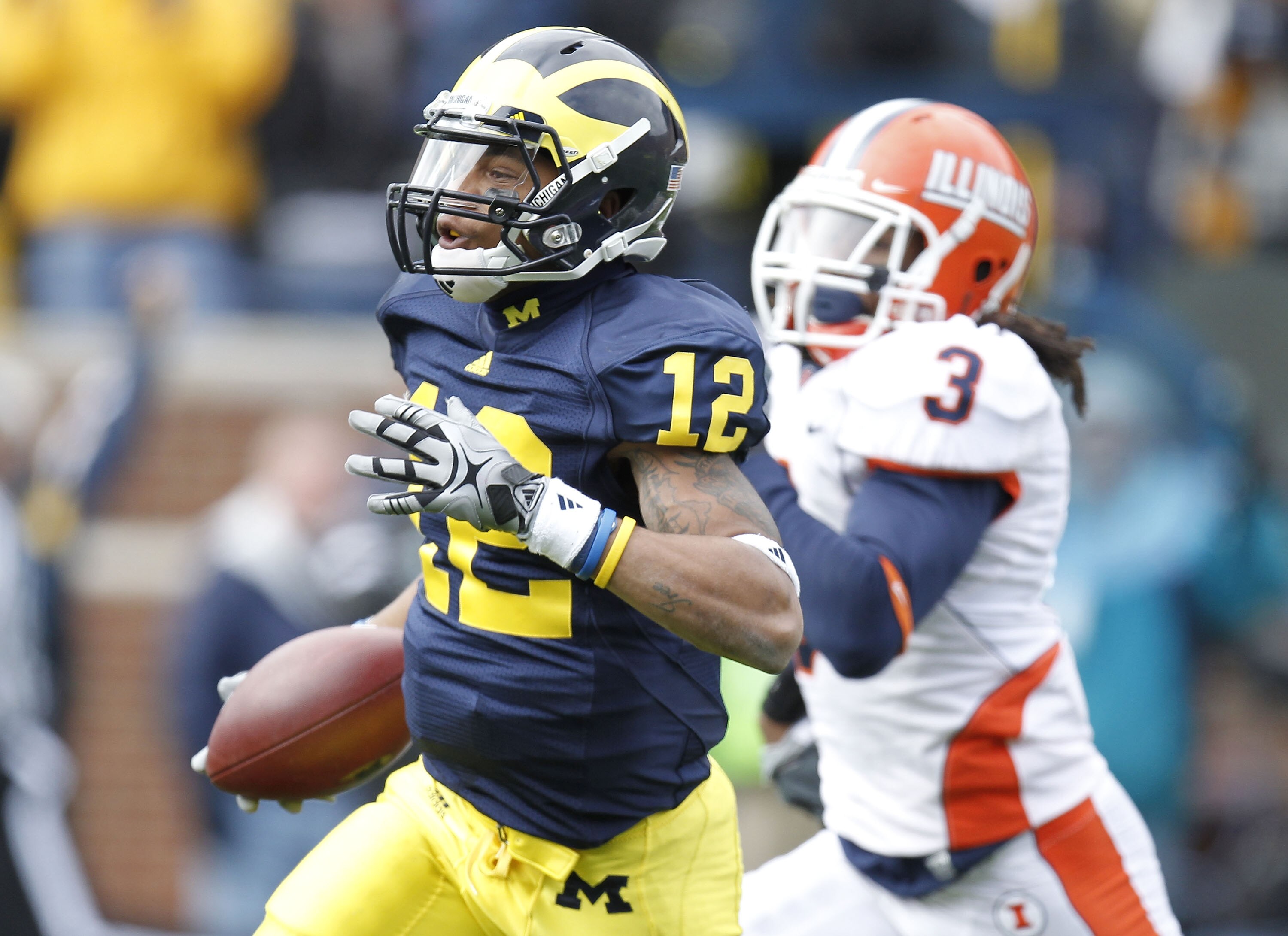 ANN ARBOR, MI - NOVEMBER 06:  Roy Roundtree #12 of the Michigan Wolverines gets past the tackle of Tavon Wilson #3 of the Illinios Fighting Illini after a second quarter reception at Michigan Stadium on November 6, 2010 in Ann Arbor, Michigan.  (Photo by