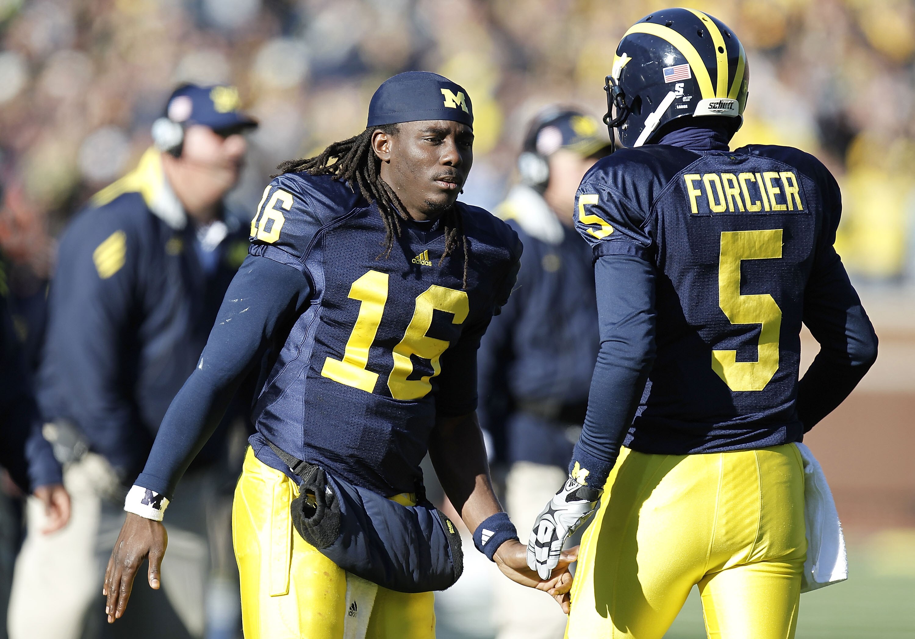 ANN ARBOR, MI - NOVEMBER 06:  Denard Robinson #16 of the Michigan Wolverines congratulates Tate Forcier #5 after scoring in the second overtime while playing the Illinios Fighting Illini at Michigan Stadium on November 6, 2010 in Ann Arbor, Michigan. Robi