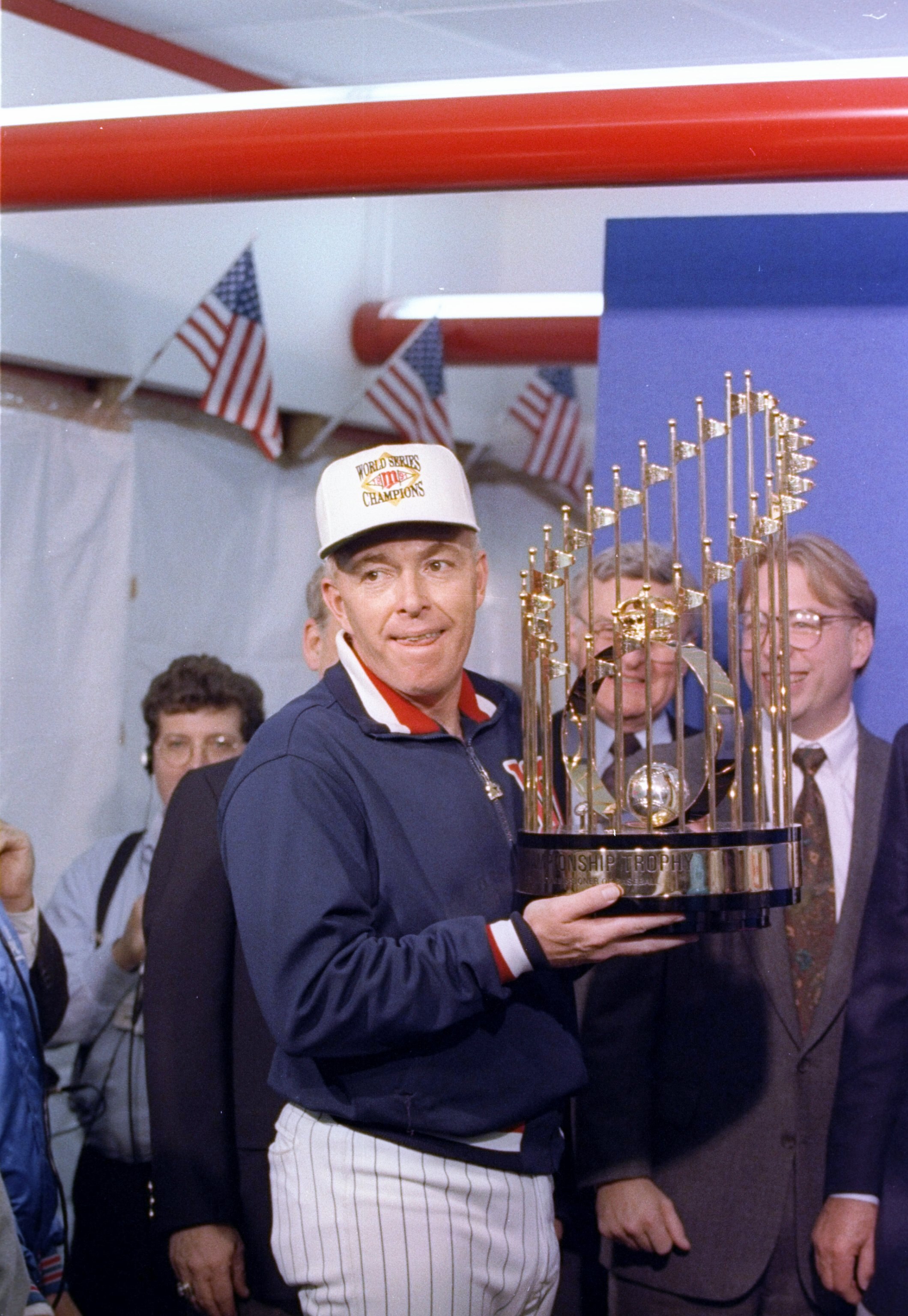 Manager Tom Kelly of the Minnesota Twins celebrates with the trophy after game seven of the World Series against the Atlanta Braves.