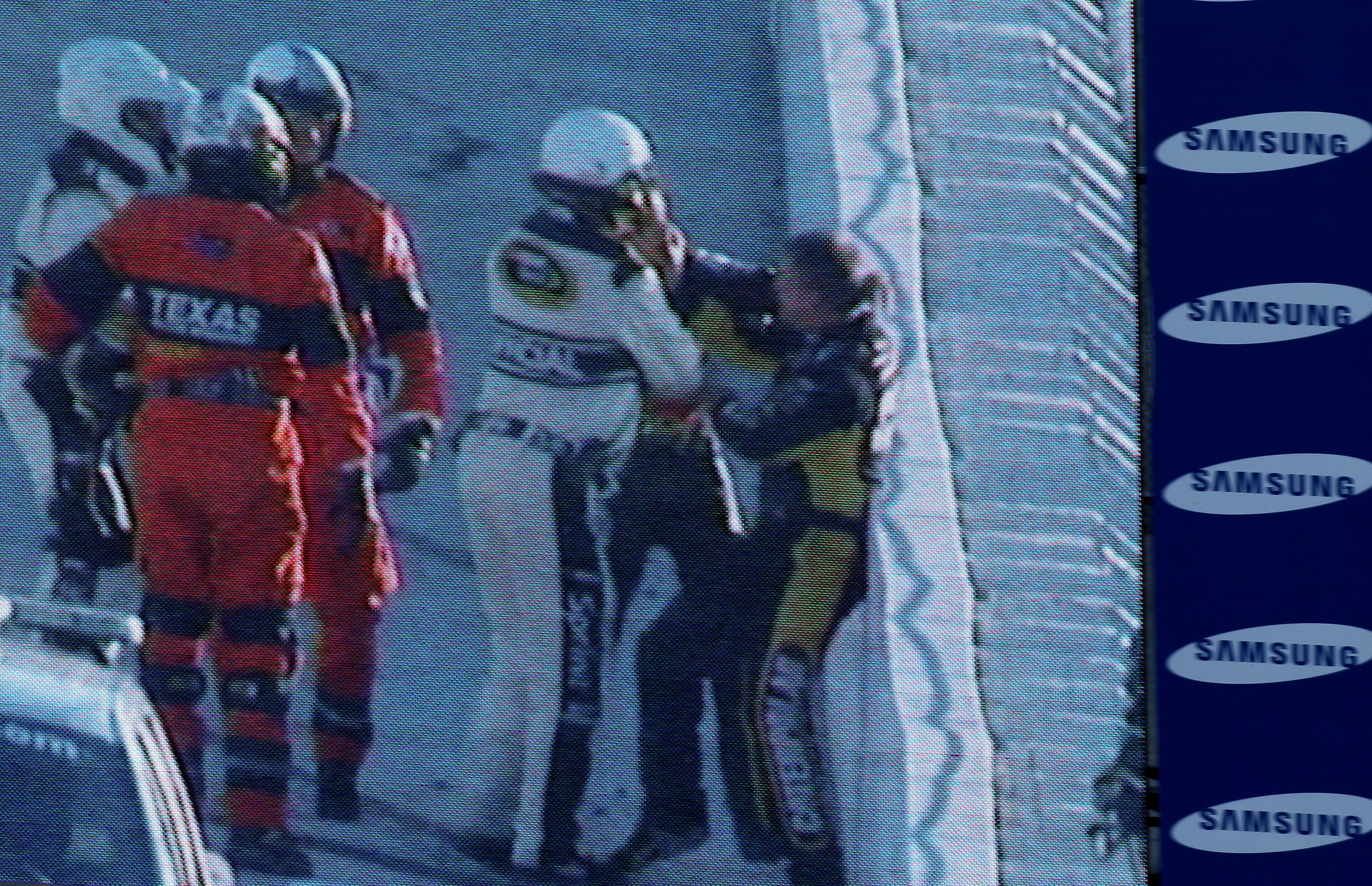 FORT WORTH, TX - NOVEMBER 07:  NASCAR officials break up a fight between Jeff Gordon (2R), driver of the #24 DuPont/National Guard Chevrolet, and Jeff Burton (R), driver of the #31 Caterpillar Chevrolett, as seen on the Sprint Vision screen in the infield