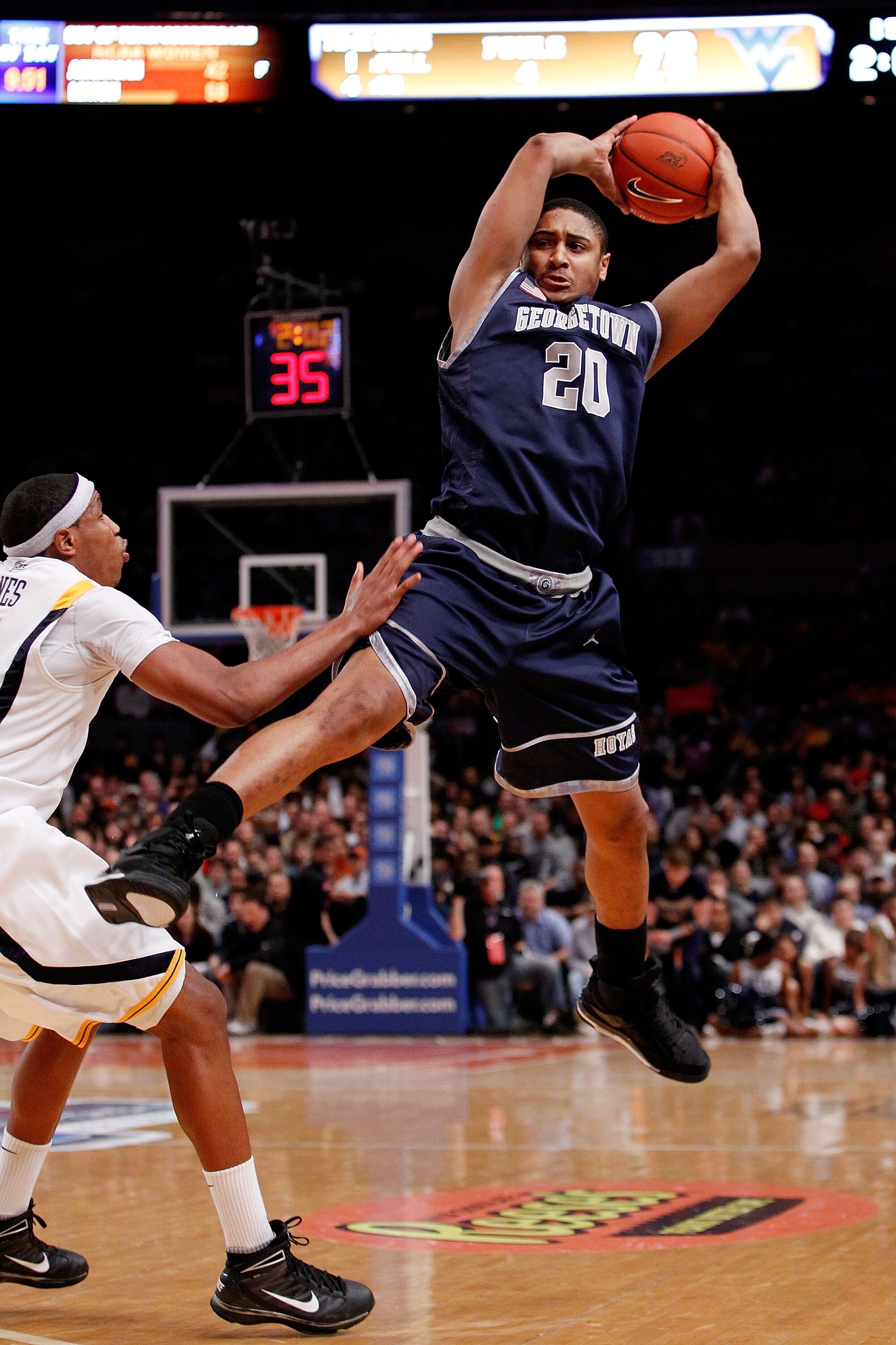 NEW YORK - MARCH 13:  Jerrelle Benimon #20 of the Georgetown Hoyas catches the inbounds pass against Kevin Jones #5 of the West Virginia Mountaineers during the championship of the 2010 NCAA Big East Tournament at Madison Square Garden on March 13, 2010 i