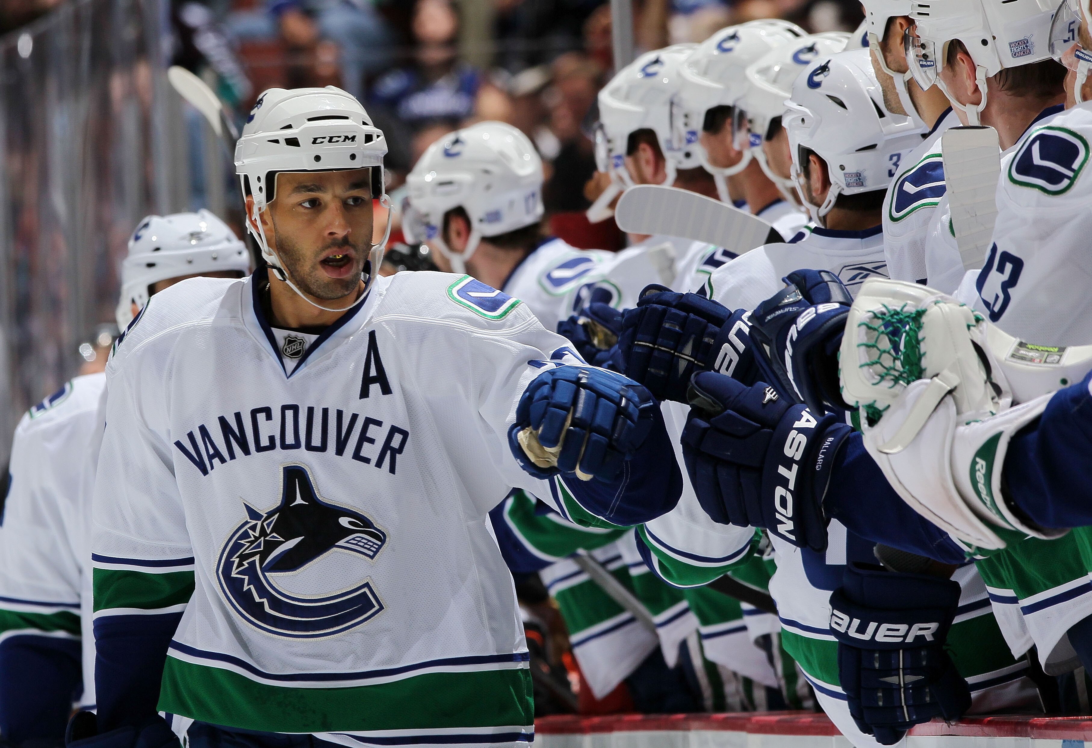 ANAHEIM, CA - OCTOBER 13:  Manny Malhotra #27 of the Vancouver Canucks celebrates with teammates during their game against the Anaheim Ducks at Honda Center on October 13, 2010 in Anaheim, California.  (Photo by Jeff Gross/Getty Images)