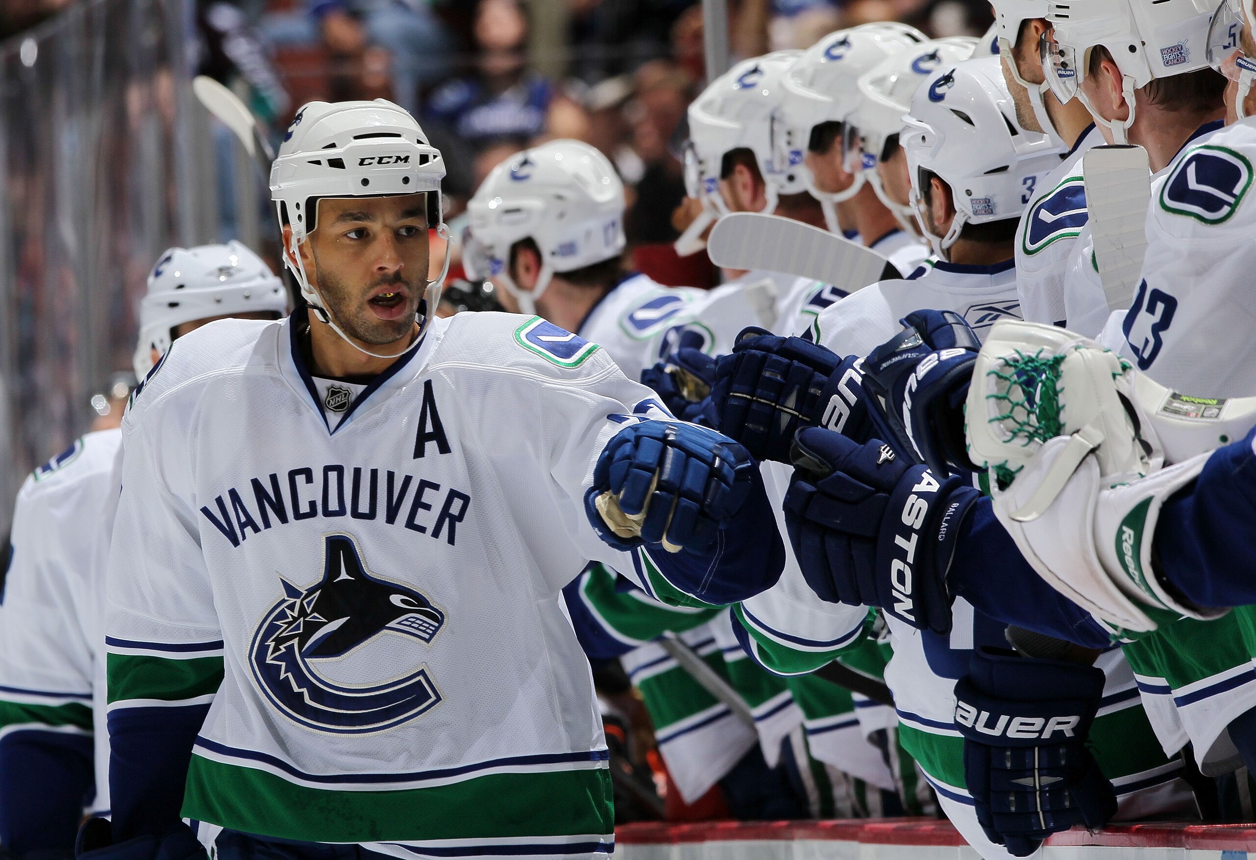 ANAHEIM, CA - OCTOBER 13:  Manny Malhotra #27 of the Vancouver Canucks celebrates with teammates during their game against the Anaheim Ducks at Honda Center on October 13, 2010 in Anaheim, California.  (Photo by Jeff Gross/Getty Images)