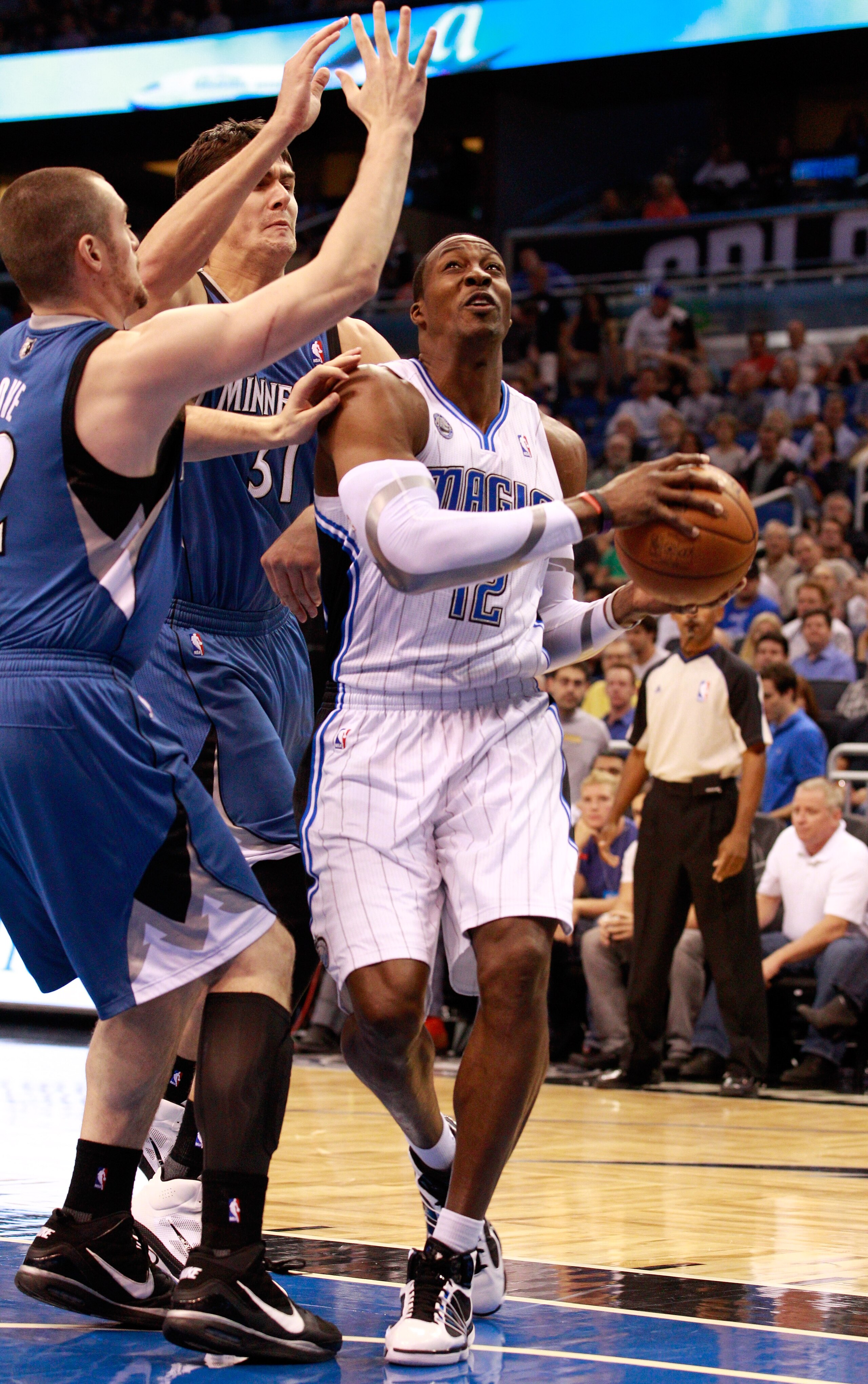 ORLANDO, FL - NOVEMBER 03: Dwight Howard #12 of the Orlando Migic drives against Darko Milicic #31 and Kevin Love #42 of the Minnesota Timberwolves during the game at Amway Arena on November 3, 2010 in Orlando, Florida. NOTE TO USER: User expressly ackn ORLANDO, FL - NOVEMBER 03: Dwight Howard #12 of the Orlando Migic drives against Darko Milicic #31 and Kevin Love #42 of the Minnesota Timberwolves during the game at Amway Arena on November 3, 2010 in Orlando, Florida. NOTE TO USER: User expressly ackn