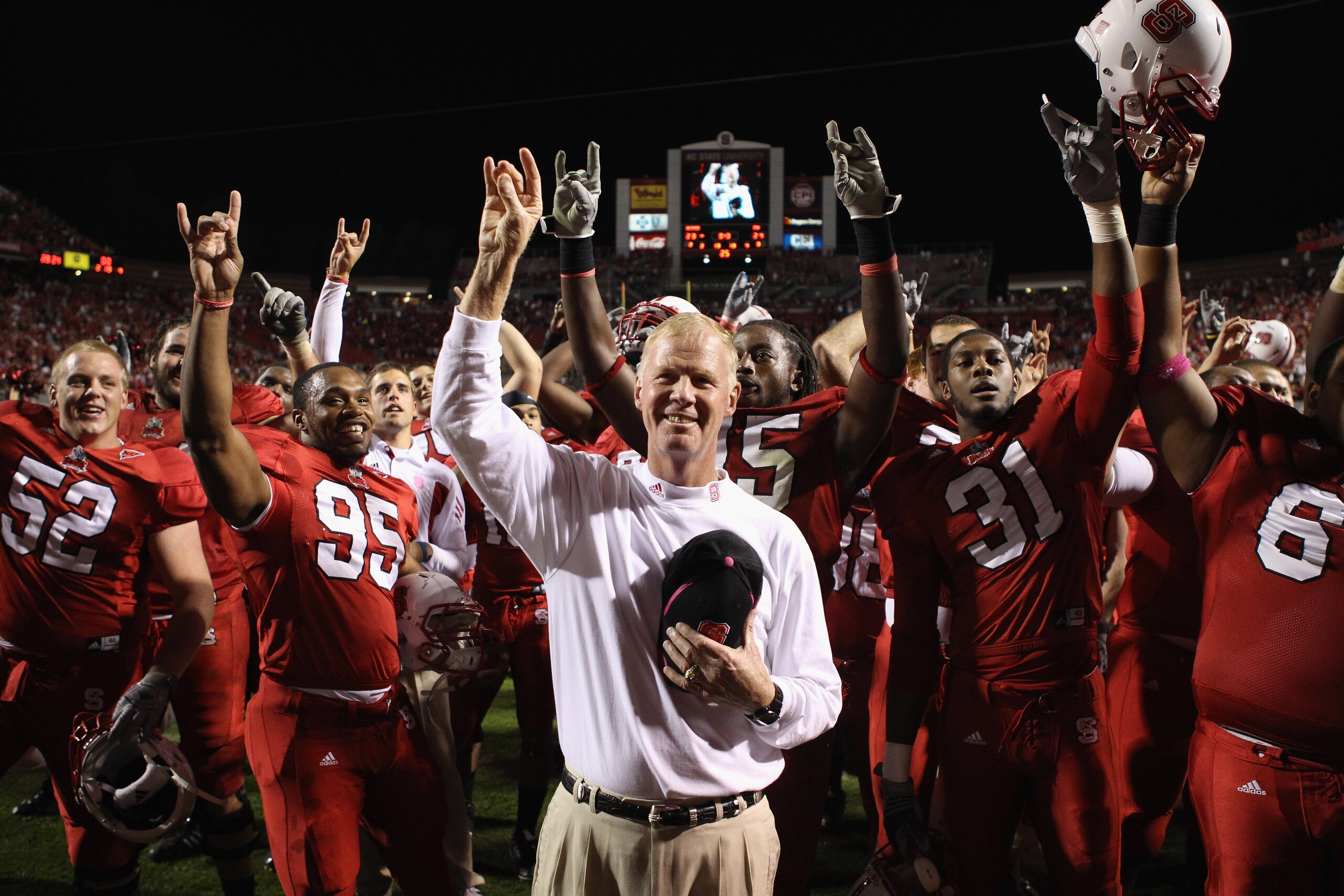 RALEIGH, NC - OCTOBER 28:  Head coach Tom O'Brien of the North Carolina State Wolfpack celebrates with his team after defeating the Florida State Seminoles 28-24 during their game at Carter-Finley Stadium on October 28, 2010 in Raleigh, North Carolina.  (