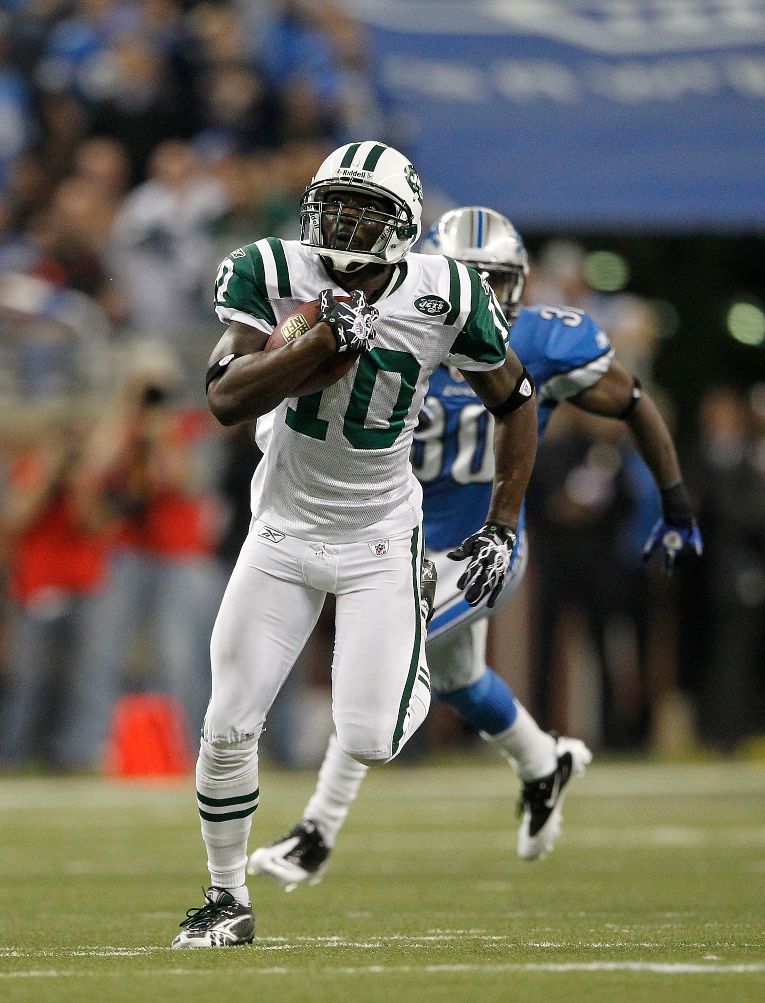 DETROIT - NOVEMBER 07: Santonio Holmes #10 of the New York Jets catches a 54 yard pass in overtime and is tackled by Landon Johnson #54 of the Detroit Lions during the overtime period at Ford Field on November 7, 2010 in Detroit, Michigan. The Jets defea DETROIT - NOVEMBER 07: Santonio Holmes #10 of the New York Jets catches a 54 yard pass in overtime and is tackled by Landon Johnson #54 of the Detroit Lions during the overtime period at Ford Field on November 7, 2010 in Detroit, Michigan. The Jets defea