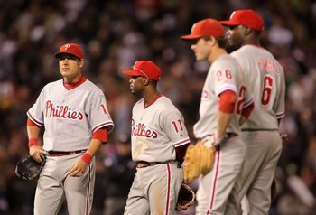 DENVER - OCTOBER 06:  Greg Dobbs #19 and Jimmy Rollins #11 of the Philadelphia Phillies stand on the field during Game Three of the National League Divisional Series against the Colorado Rockies at Coors Field on October 6, 2007 in Denver, Colorado. The R