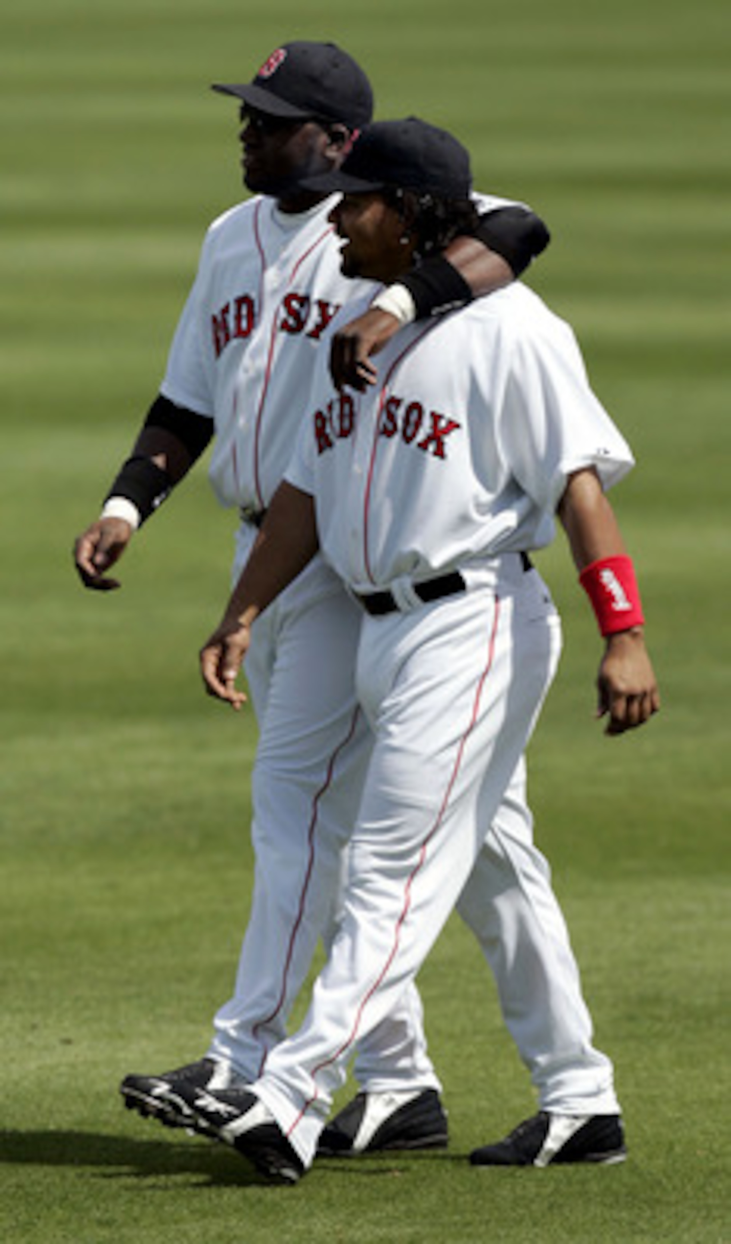 FORT MYERS, FL - MARCH 6:  David Ortiz #34 and teammate Manny Ramirez #34 of the Boston Red Sox walk in the outfield before the start of their game against the Philadelphia Phillies on March 6, 2005 at Wilbur Billy Smith Field in Fort Myers, Florida.  (Ph