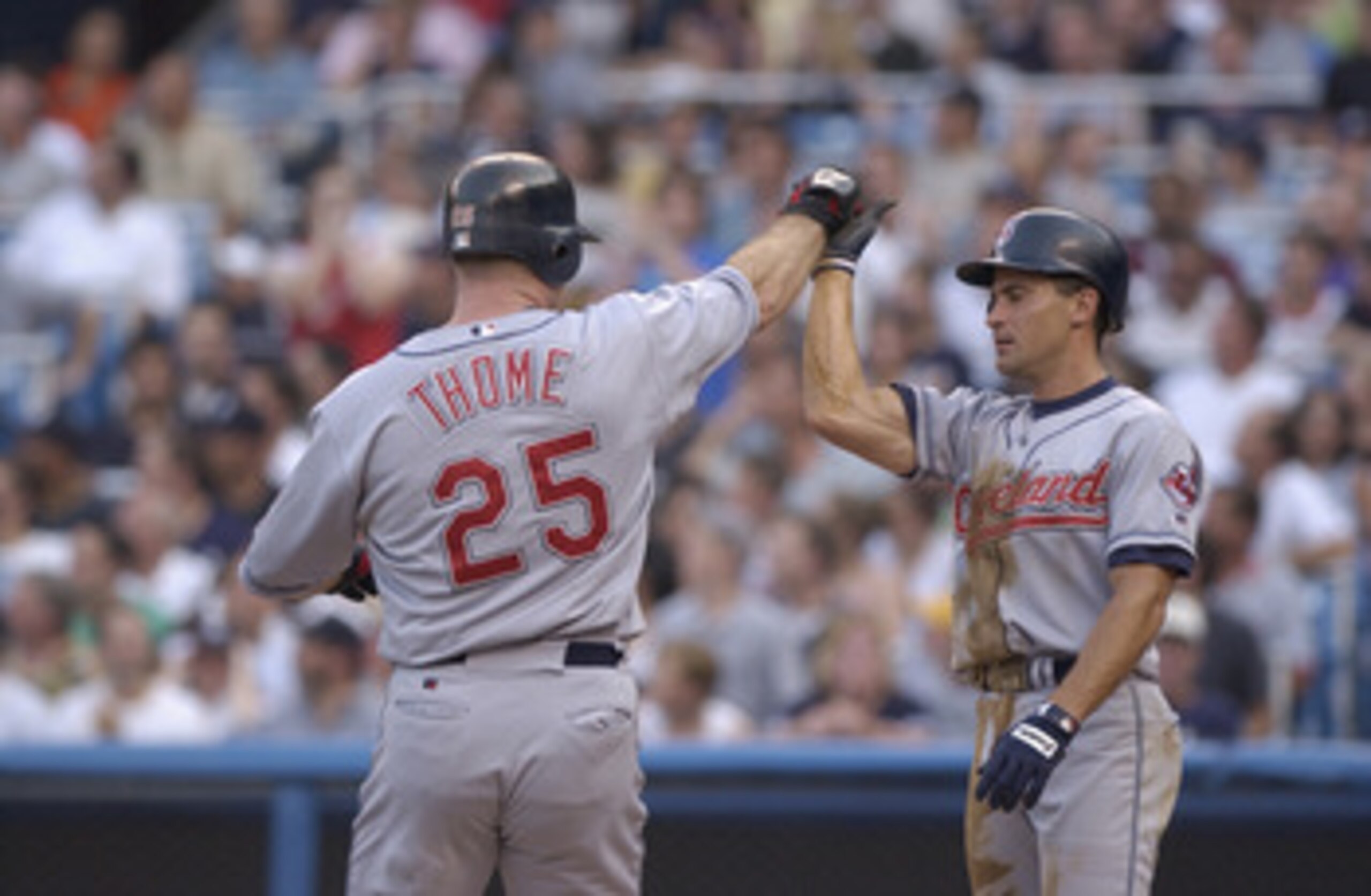 BRONX, NY - JULY 02:  Omar Vizquel #13 congratulates teammate Jim Thome #25 of the Cleveland Indians at home plate against the New York Yankees during the game on July 2, 2002 at Yankee Stadium in the Bronx, New York.  The Yankees won 10-5.  (Photo by Ezr