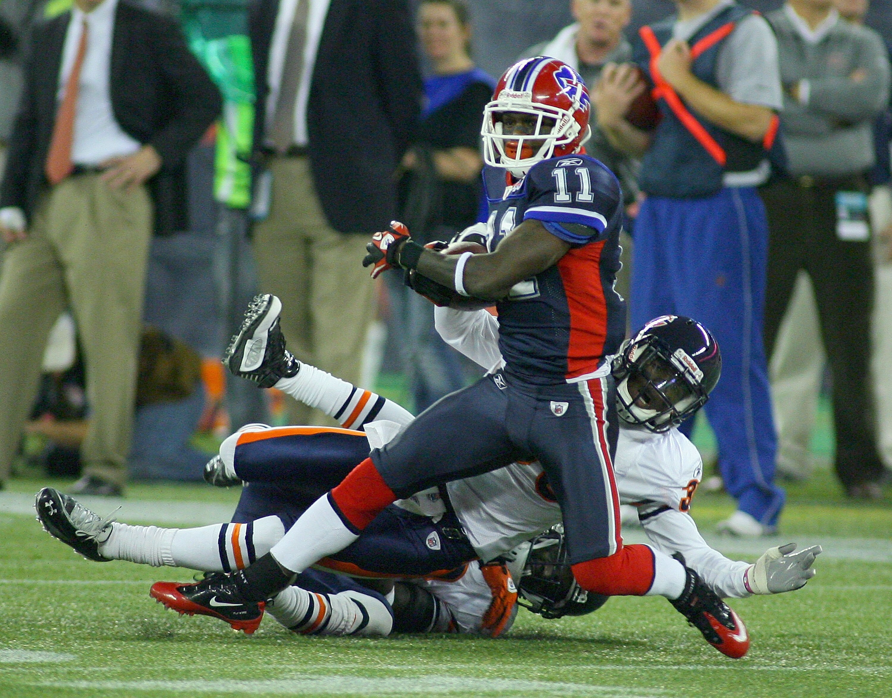 TORONTO, ON - NOVEMBER 07:  Roscoe Parrish #11 of the Buffalo Bills struggles against  D.J. Moore #30 and Charles Tillman #33 of the Chicago Bears at Rogers Centre on November 7, 2010 in Toronto, Canada.  Chicago won 22-19.  (Photo by Rick Stewart/Getty I