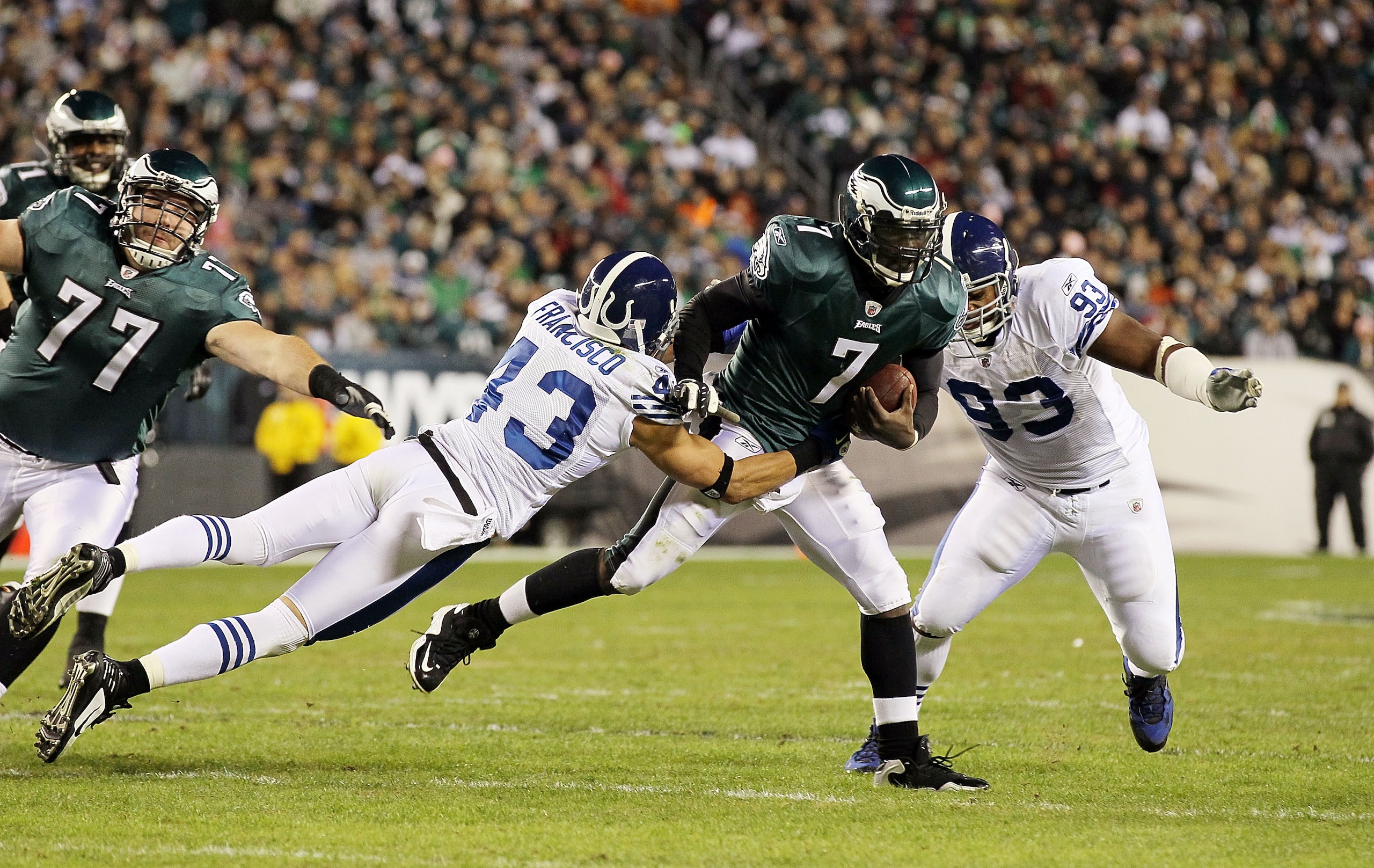 PHILADELPHIA - NOVEMBER 07:  Michael Vick #7 of the Philadelphia Eagles runs the ball against Aaron Francisco #43 and Dwight Freeney #93 of the Indianapolis Colts on November 7, 2010 at Lincoln Financial Field in Philadelphia, Pennsylvania.  (Photo by Jim