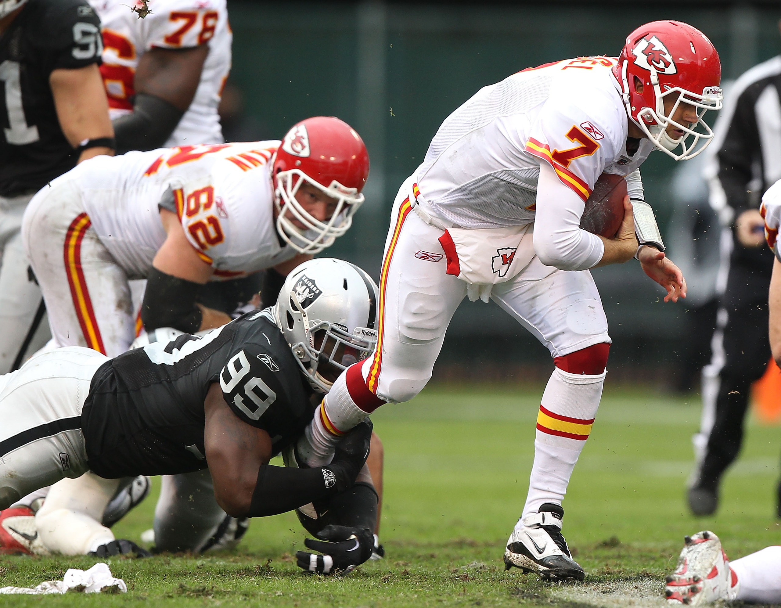 OAKLAND, CA - NOVEMBER 07:  Matt Cassel #7 of the Kansas City Chiefs runs with the ball against Lamarr Houston #99 of the Oakland Raiders during an NFL game at Oakland-Alameda County Coliseum on November 7, 2010 in Oakland, California.  (Photo by Jed Jaco