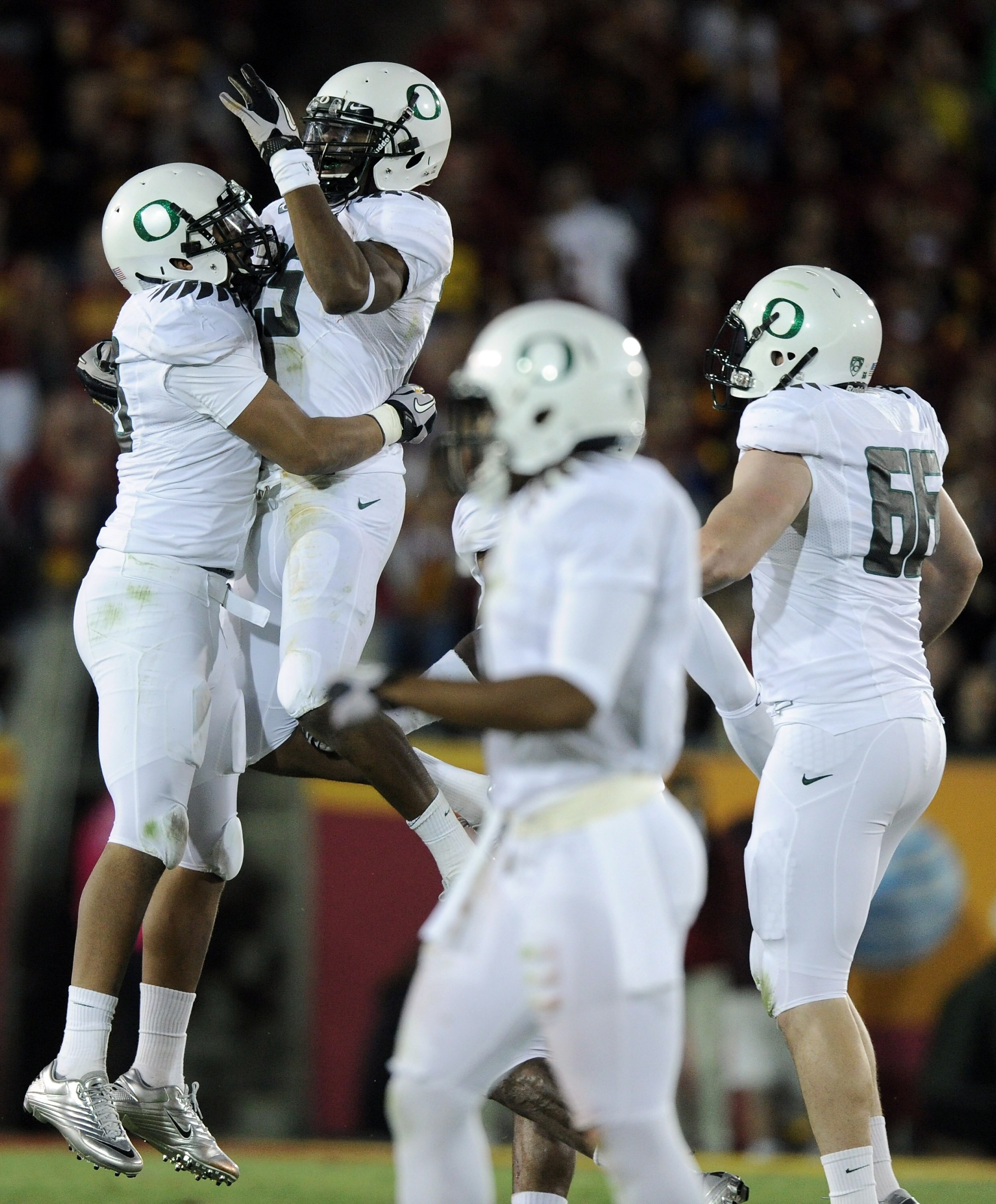 LOS ANGELES, CA - OCTOBER 30:  Boseko Lokombo #25 of the Oregon Ducks reacts to his fumble recovery with Karrington Armstrong #78 against the USC Trojans during the second quarter at Los Angeles Memorial Coliseum on October 30, 2010 in Los Angeles, Califo