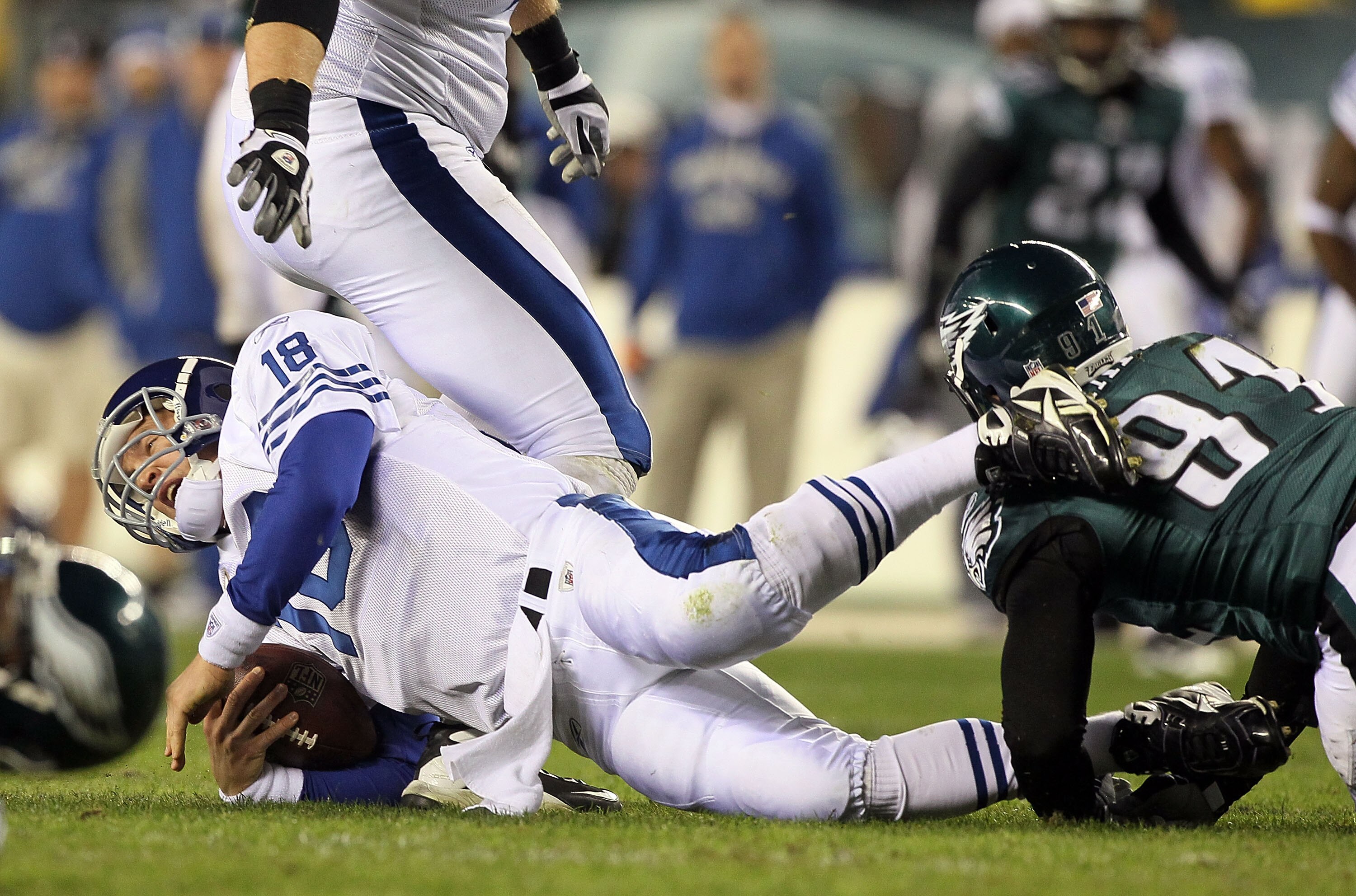 PHILADELPHIA - NOVEMBER 07:  Peyton Manning #18 of the Indianapolis Colts is sacked in the second quarter by Darryl Tapp #91 of the Philadelphia Eagles on November 7, 2010 at Lincoln Financial Field in Philadelphia, Pennsylvania.  (Photo by Jim McIsaac/Ge
