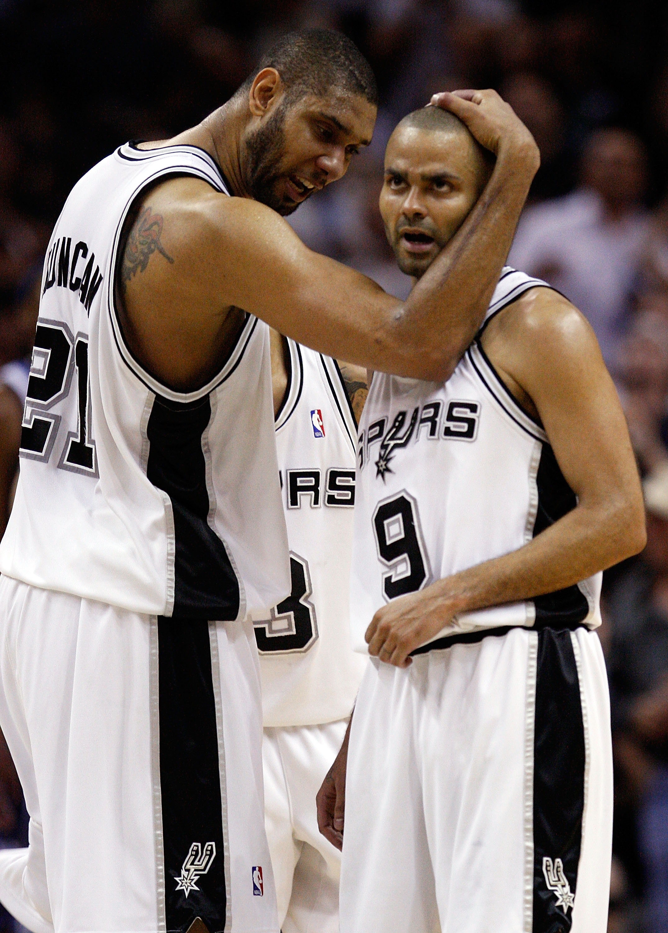 SAN ANTONIO - APRIL 23: Forward Tim Duncan #21 and Tony Parker #9 of the San Antonio Spurs react during a 94-90 win against the Dallas Mavericks in Game Three of the Western Conference Quarterfinals during the 2010 NBA Playoffs at AT&T Center on April 23 SAN ANTONIO - APRIL 23: Forward Tim Duncan #21 and Tony Parker #9 of the San Antonio Spurs react during a 94-90 win against the Dallas Mavericks in Game Three of the Western Conference Quarterfinals during the 2010 NBA Playoffs at AT&T Center on April 23