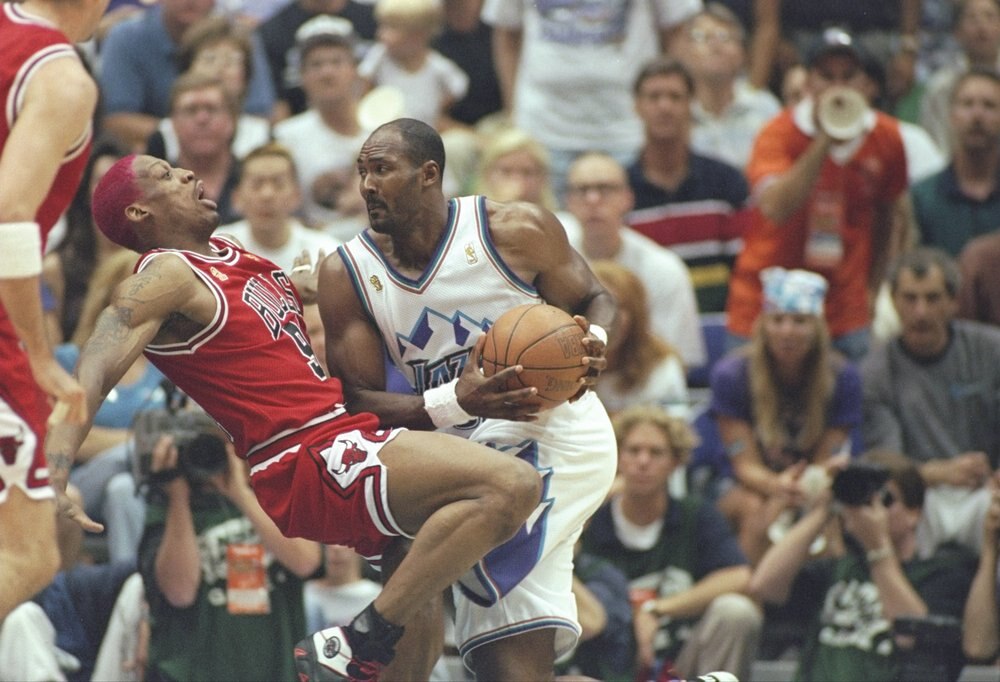 Rodman draws a charge on Karl Malone.