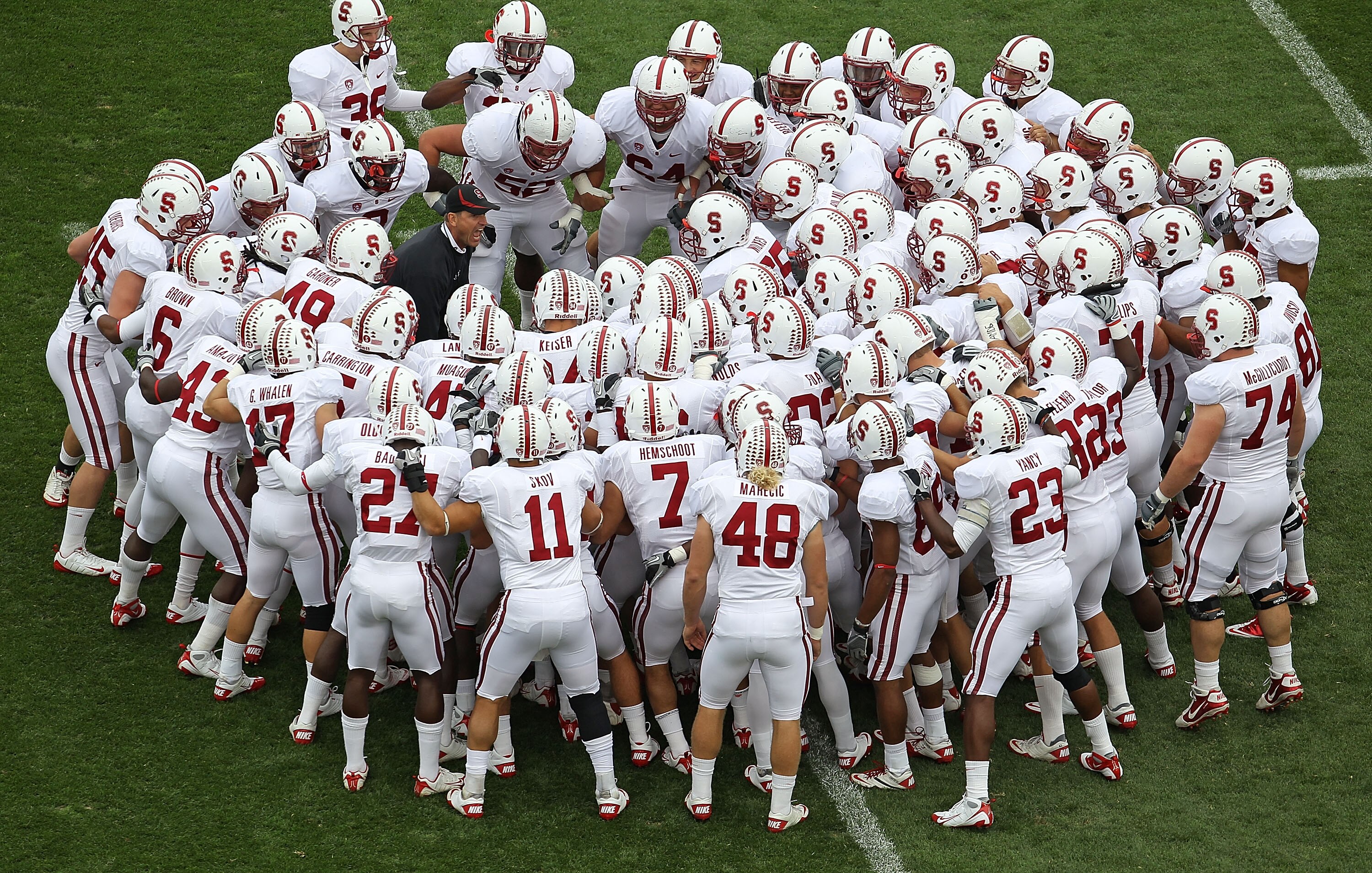 SOUTH BEND, IN - SEPTEMBER 25: Head coach Jim Harbaugh of the Stanford Cardinal (left, in blue) gets his team ready to play the Notre Dame Fighting Irish during warm-ups at Notre Dame Stadium on September 25, 2010 in South Bend, Indiana. (Photo by Jonatha