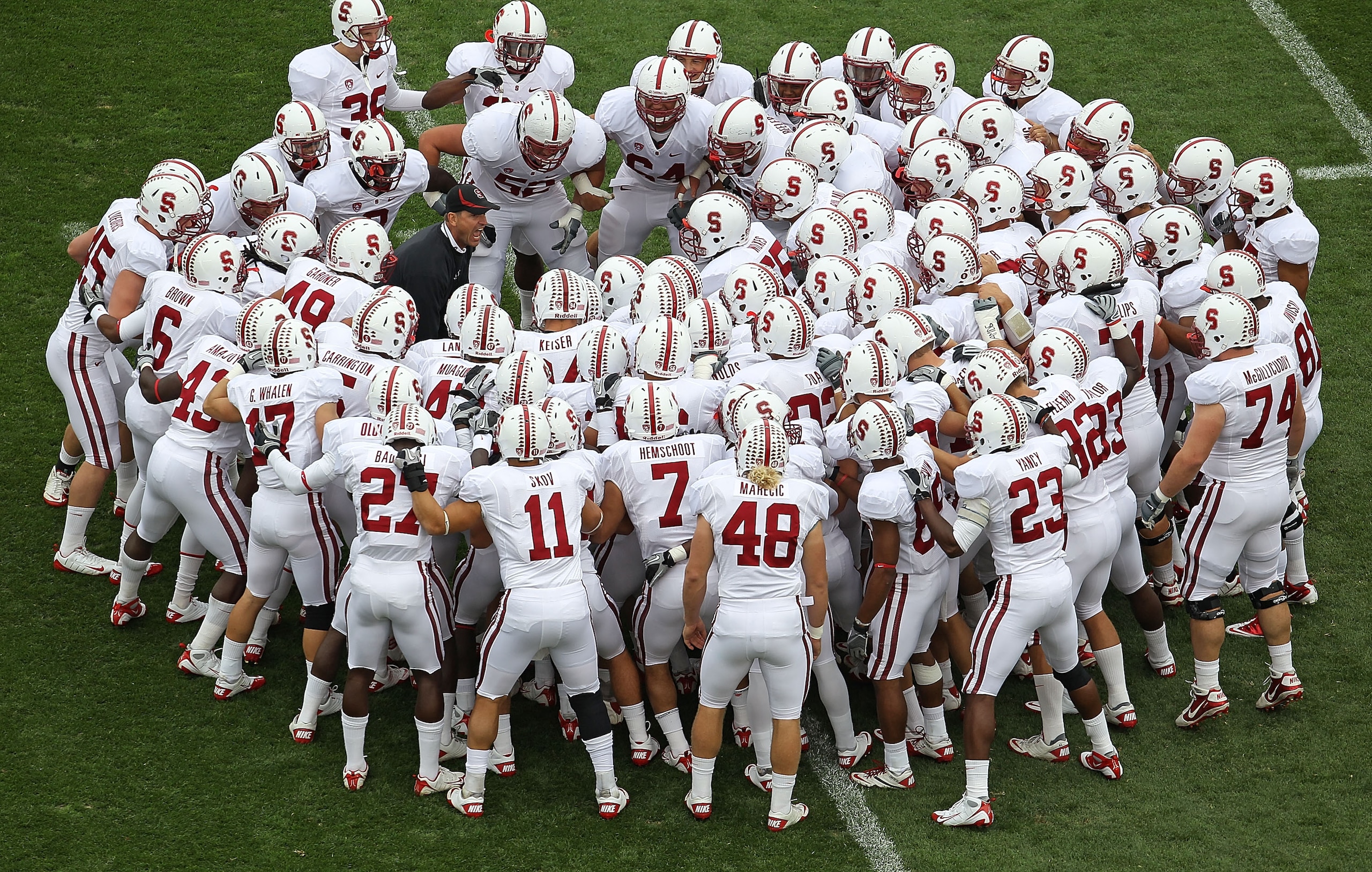 SOUTH BEND, IN - SEPTEMBER 25: Head coach Jim Harbaugh of the Stanford Cardinal (left, in blue) gets his team ready to play the Notre Dame Fighting Irish during warm-ups at Notre Dame Stadium on September 25, 2010 in South Bend, Indiana. (Photo by Jonatha SOUTH BEND, IN - SEPTEMBER 25: Head coach Jim Harbaugh of the Stanford Cardinal (left, in blue) gets his team ready to play the Notre Dame Fighting Irish during warm-ups at Notre Dame Stadium on September 25, 2010 in South Bend, Indiana. (Photo by Jonatha