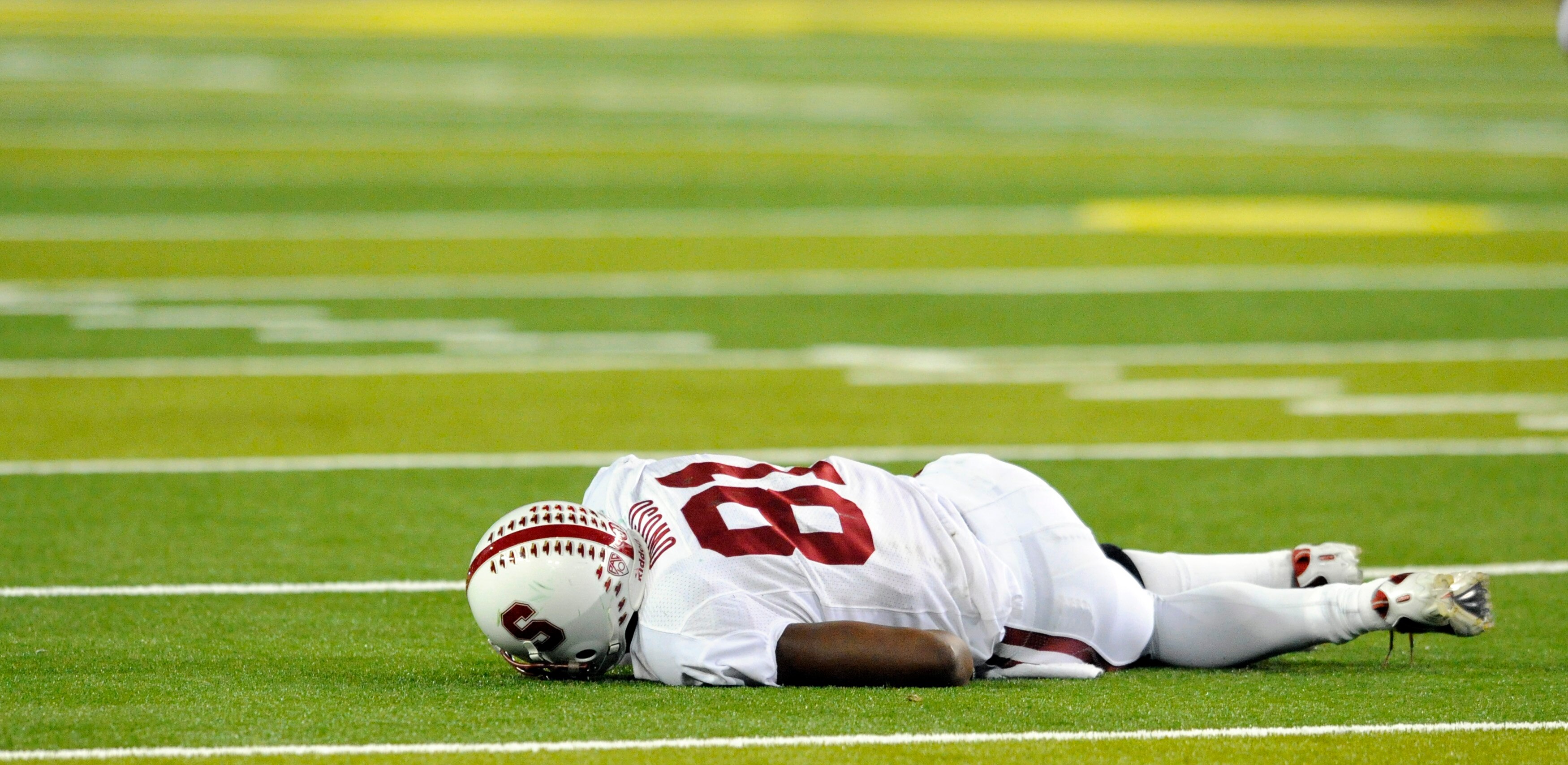 EUGENE, OR - OCTOBER 2: Wide receiver Chris Owusu #81 of the Stanford Cardinal lies on the field after being hit and fumbling the ball in the third quarter of the game against the Oregon Ducks at Autzen Stadium on October 2, 2010 in Eugene, Oregon. Oregon