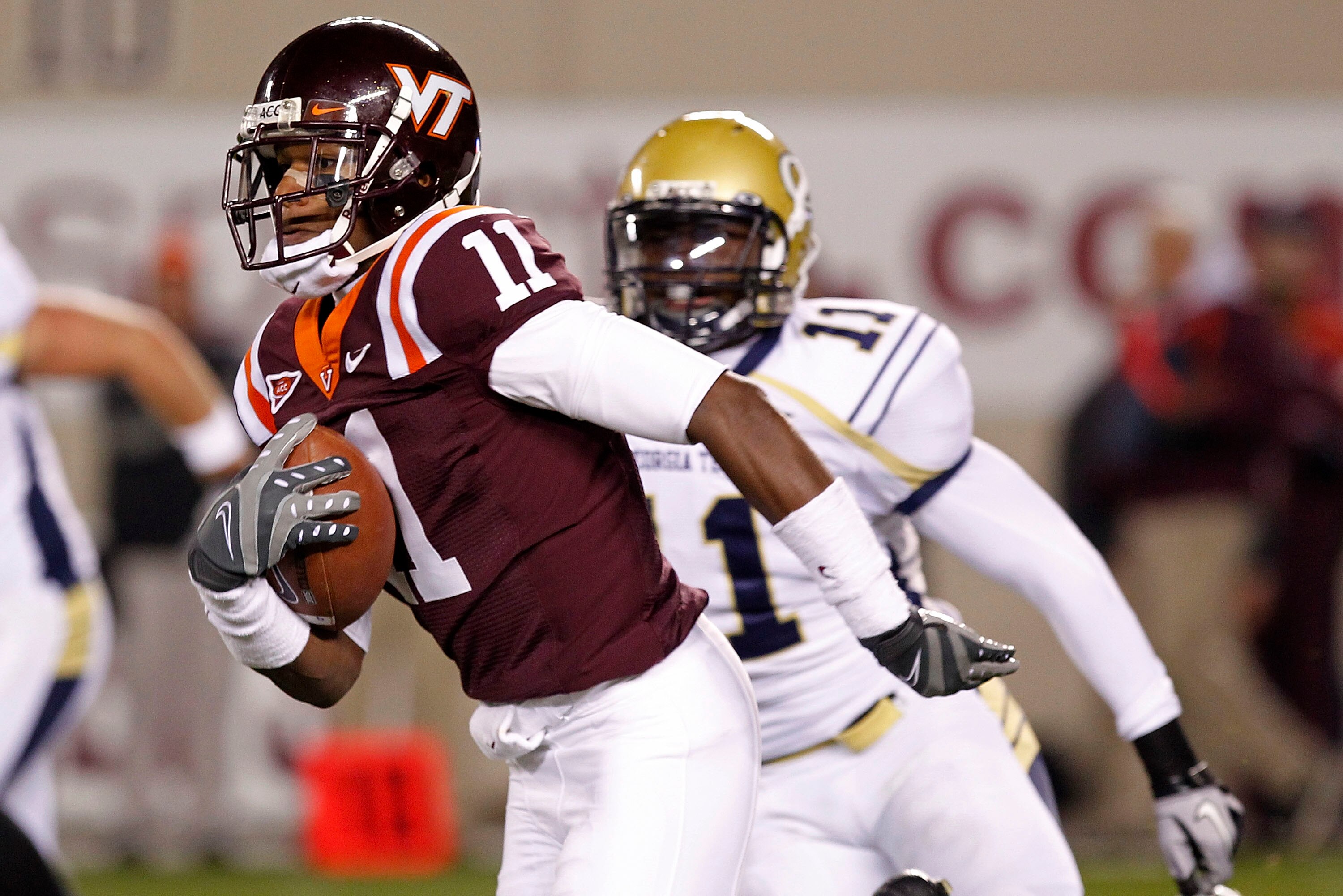 BLACKSBURG, VA - NOVEMBER 04:  Wide receiver Dyrell Roberts #11 of the Virginia Tech Hokies runs with the ball past linebacker Brandon Watts #11 of the Georgia Tech Yellow Jackets at Lane Stadium on November 4, 2010 in Blacksburg, Virginia.  (Photo by Geo