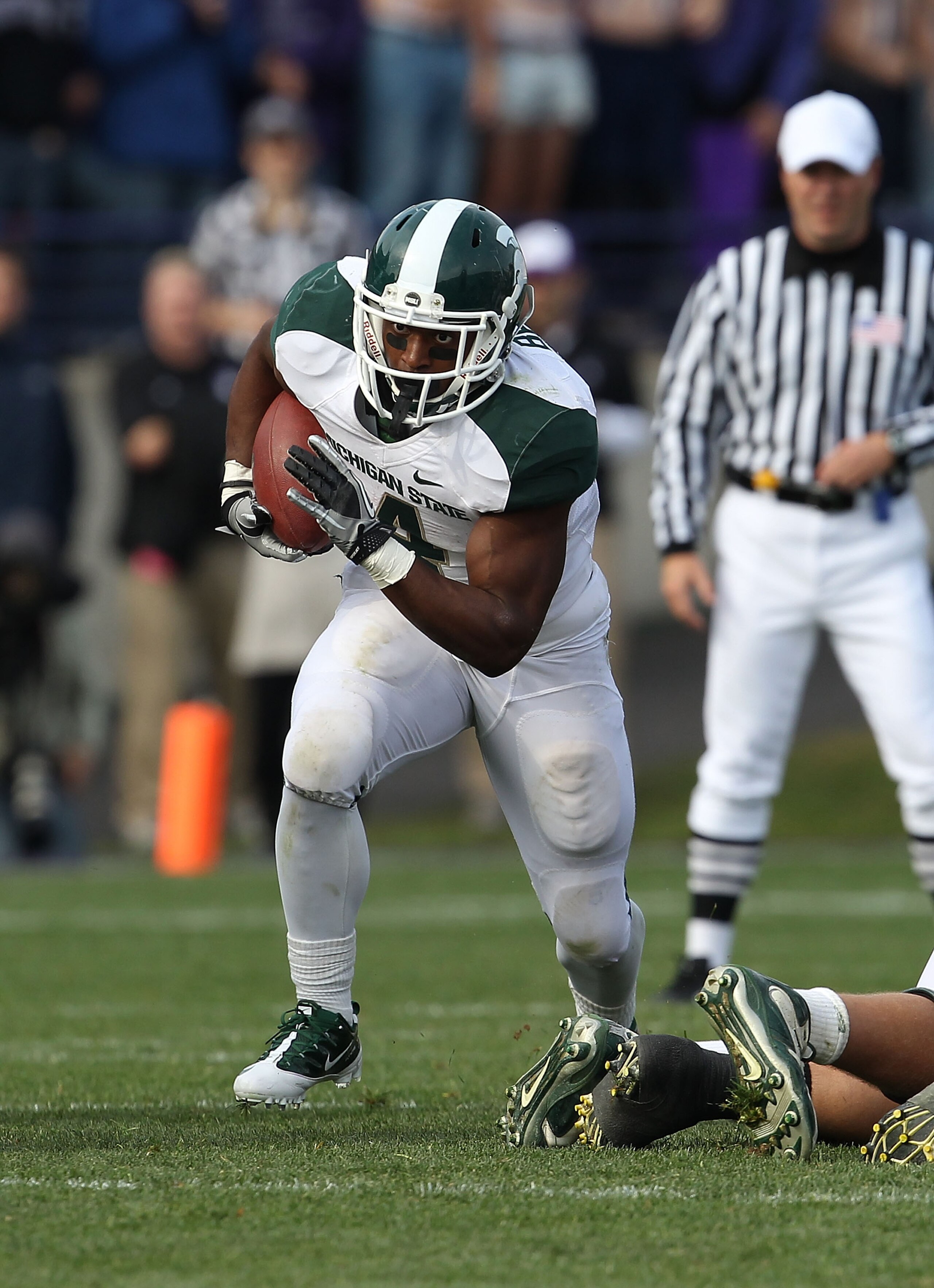 EVANSTON, IL - OCTOBER 23: Edwin Baker #4 of the Michigan State Spartans runs against the Northwestern Wildcats at Ryan Field on October 23, 2010 in Evanston, Illinois. Michigan State defeated Northwestern 35-27. (Photo by Jonathan Daniel/Getty Images) EVANSTON, IL - OCTOBER 23: Edwin Baker #4 of the Michigan State Spartans runs against the Northwestern Wildcats at Ryan Field on October 23, 2010 in Evanston, Illinois. Michigan State defeated Northwestern 35-27. (Photo by Jonathan Daniel/Getty Images)