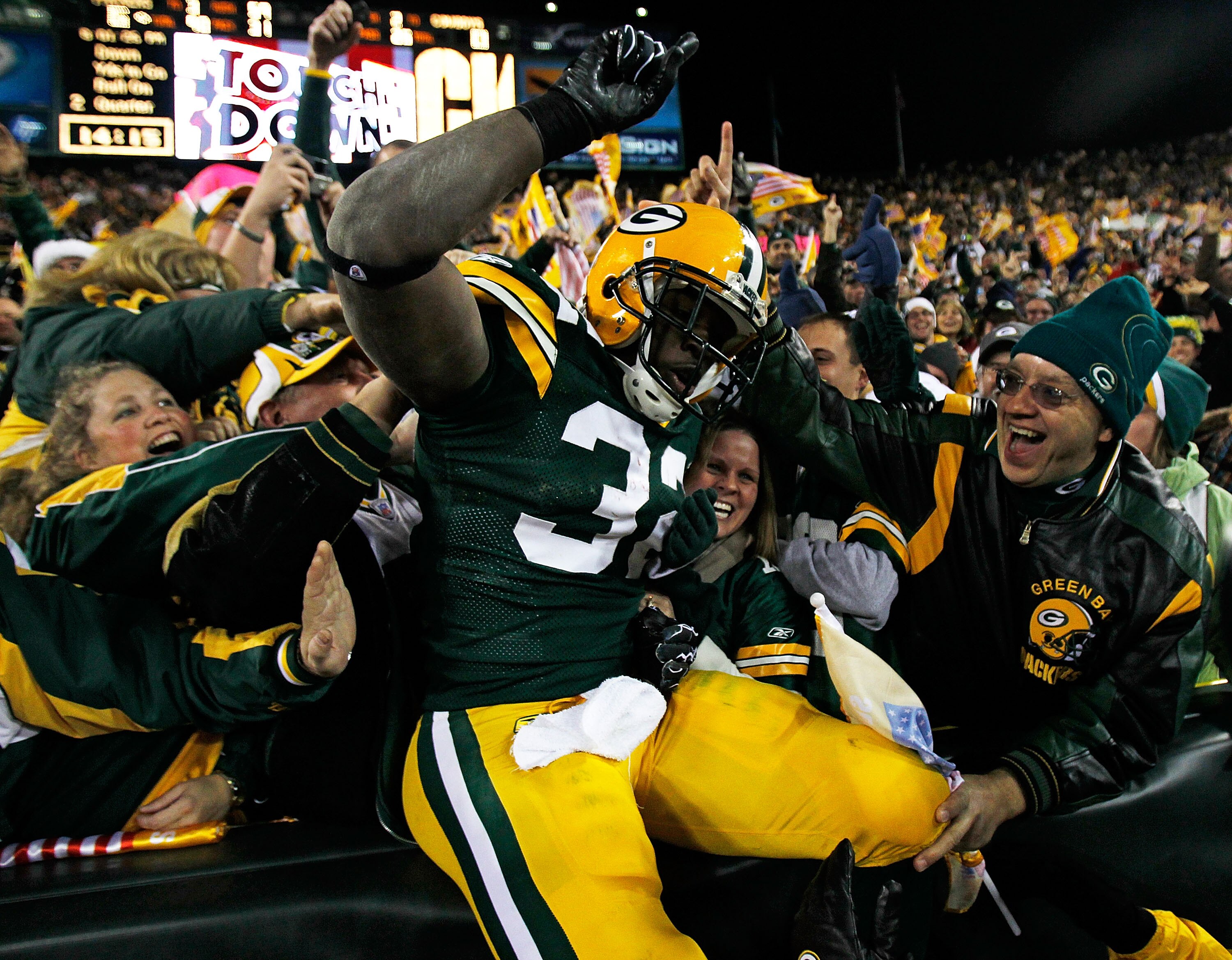 GREEN BAY, WI - NOVEMBER 07: Brandon Jackson #32 of the Green Bay Packers celebrates a touchdown with fans against the Dallas Cowboys at Lambeau Field on November 7, 2010 in Green Bay, Wisconsin. (Photo by Jonathan Daniel/Getty Images)