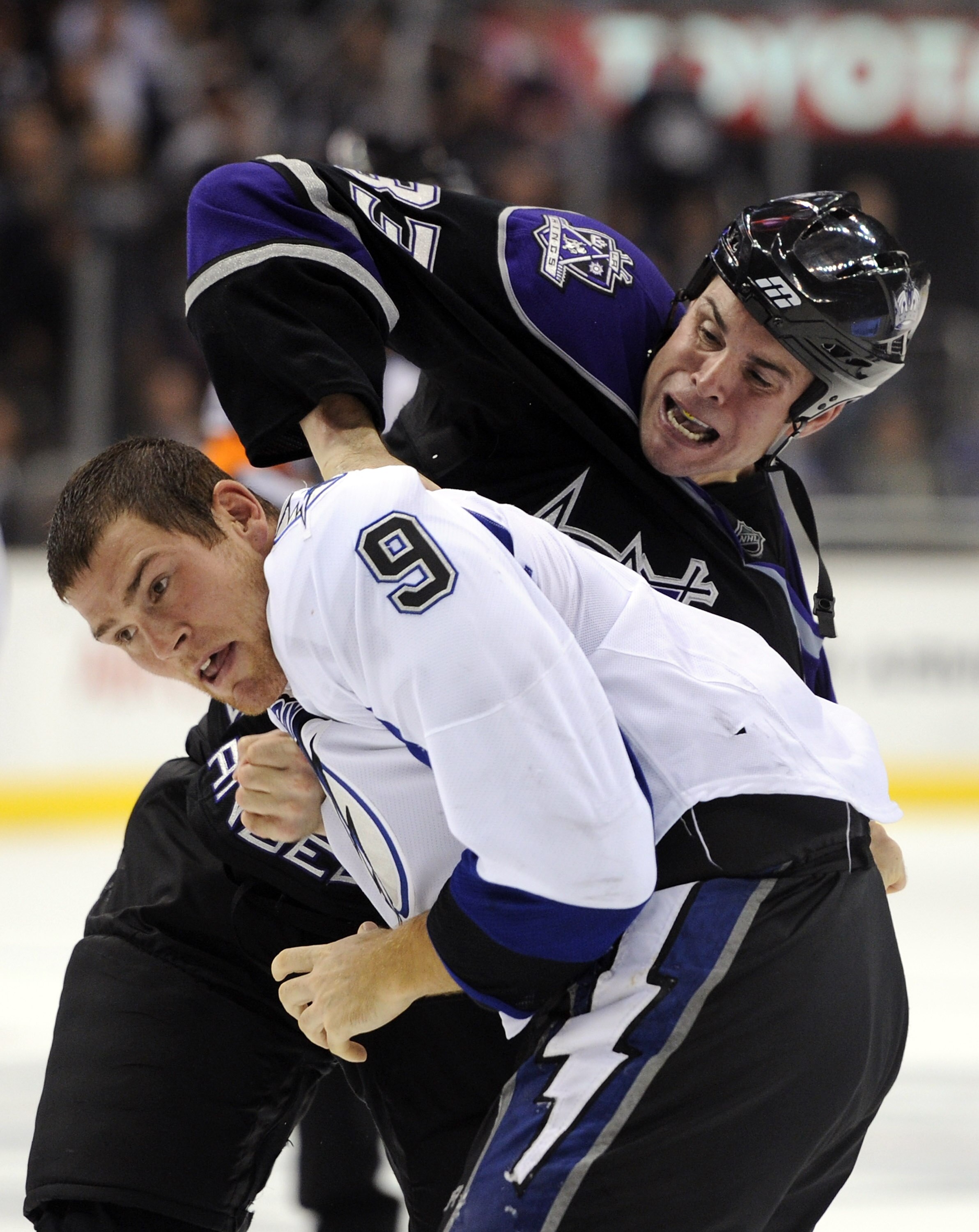 LOS ANGELES, CA - NOVEMBER 04:  Steve Downie #9 of the Tampa Bay Lightning fights with Willie Mitchell #33 of the Los Angeles Kings during the third period at Staples Center on November 4, 2010 in Los Angeles, California. The Kings won 1-0.  (Photo by Har