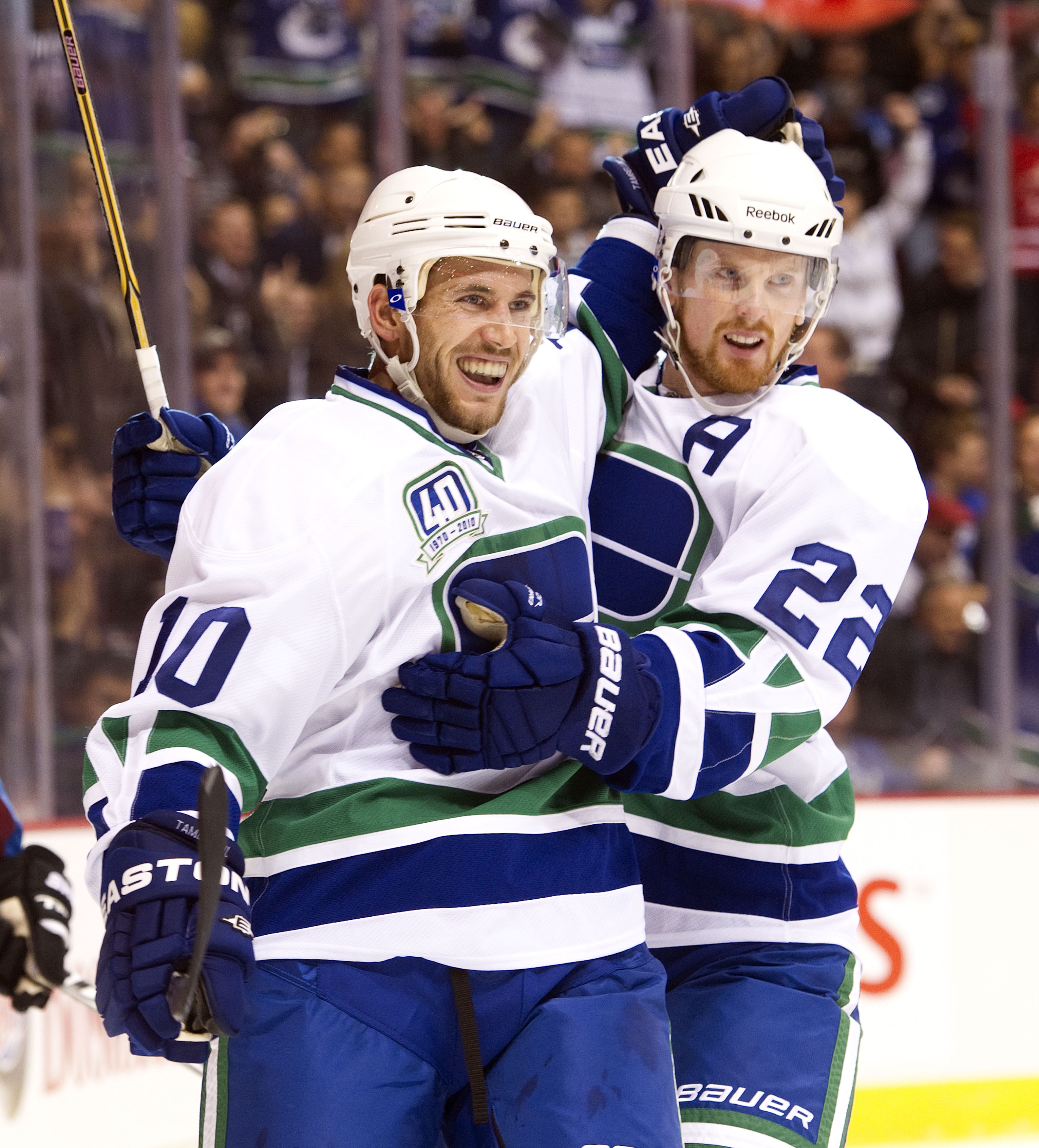 VANCOUVER, CANADA - OCTOBER 26: Jeff Tambellini #10 of the Vancouver Canucks is congratulated by Daniel Sedin #22 after scoring against the Colorado Avalanche during the first period in NHL action on October 26, 2010 at Rogers Arena in Vancouver, British