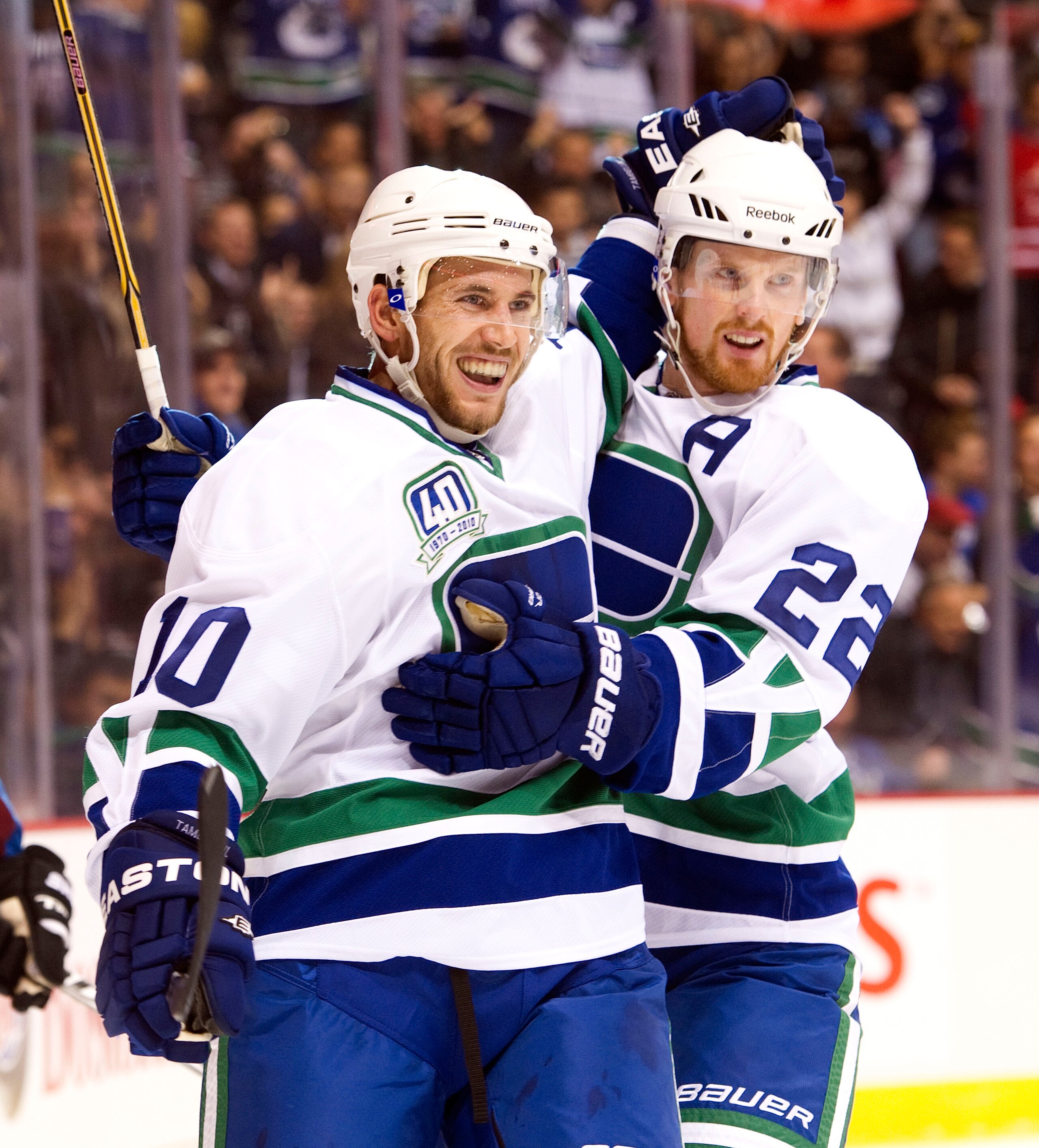 VANCOUVER, CANADA - OCTOBER 26: Jeff Tambellini #10 of the Vancouver Canucks is congratulated by Daniel Sedin #22 after scoring against the Colorado Avalanche during the first period in NHL action on October 26, 2010 at Rogers Arena in Vancouver, British