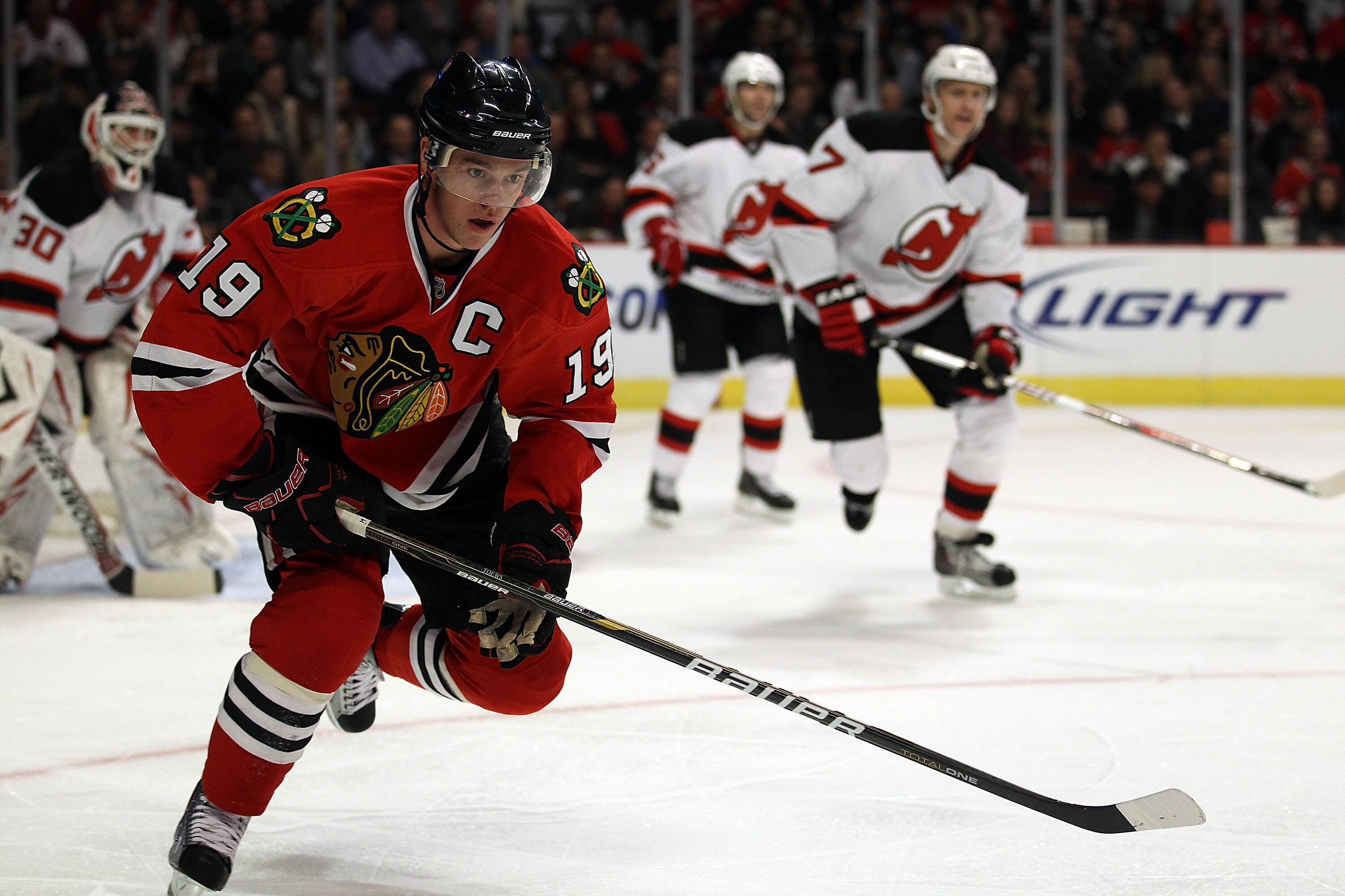 CHICAGO, IL - NOVEMBER 03: Jonathan Toews #19 of the Chicago Blackhawks skates to the puck against the New Jersey Devils at the United Center on November 3, 2010 in Chicago, Illinois. The Devils defeated the Blackhawks 5-3. (Photo by Jonathan Daniel/Getty