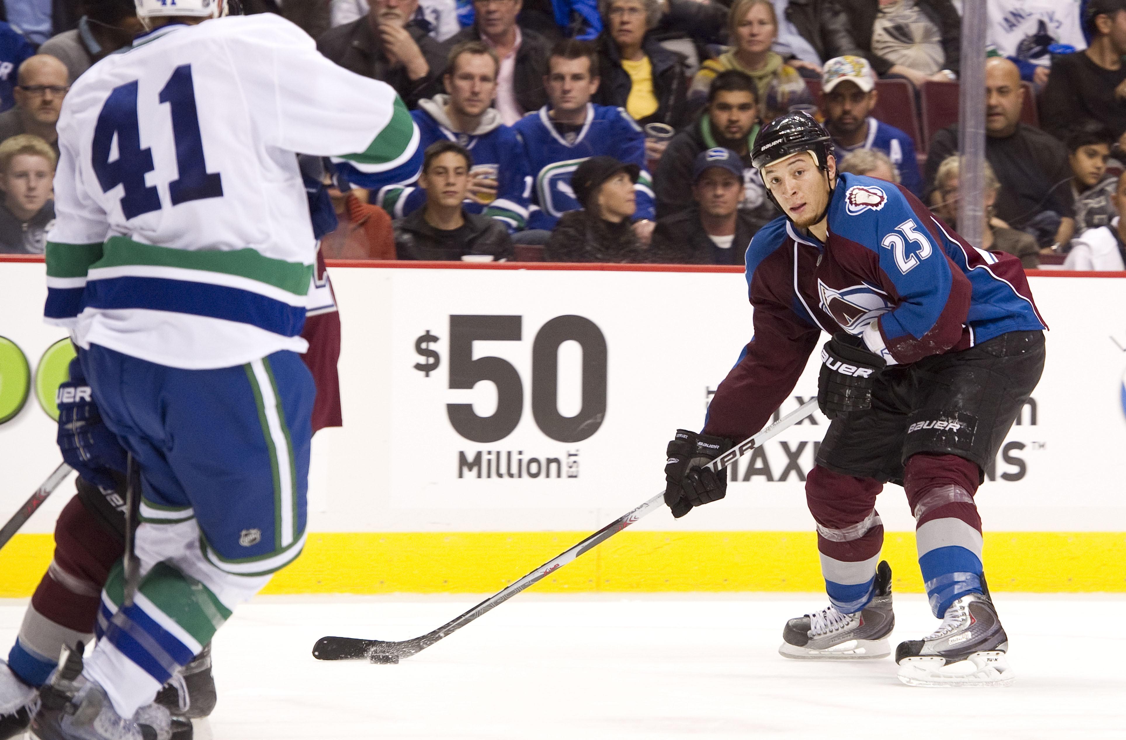 VANCOUVER, CANADA - OCTOBER 26: Chris Stewart #25 of the Colorado Avalanche looks to take a shot on net while Andrew Alberts #41 of the Vancouver Canucks tries to defend on the play during the second period in NHL action on October 26, 2010 at Rogers Aren