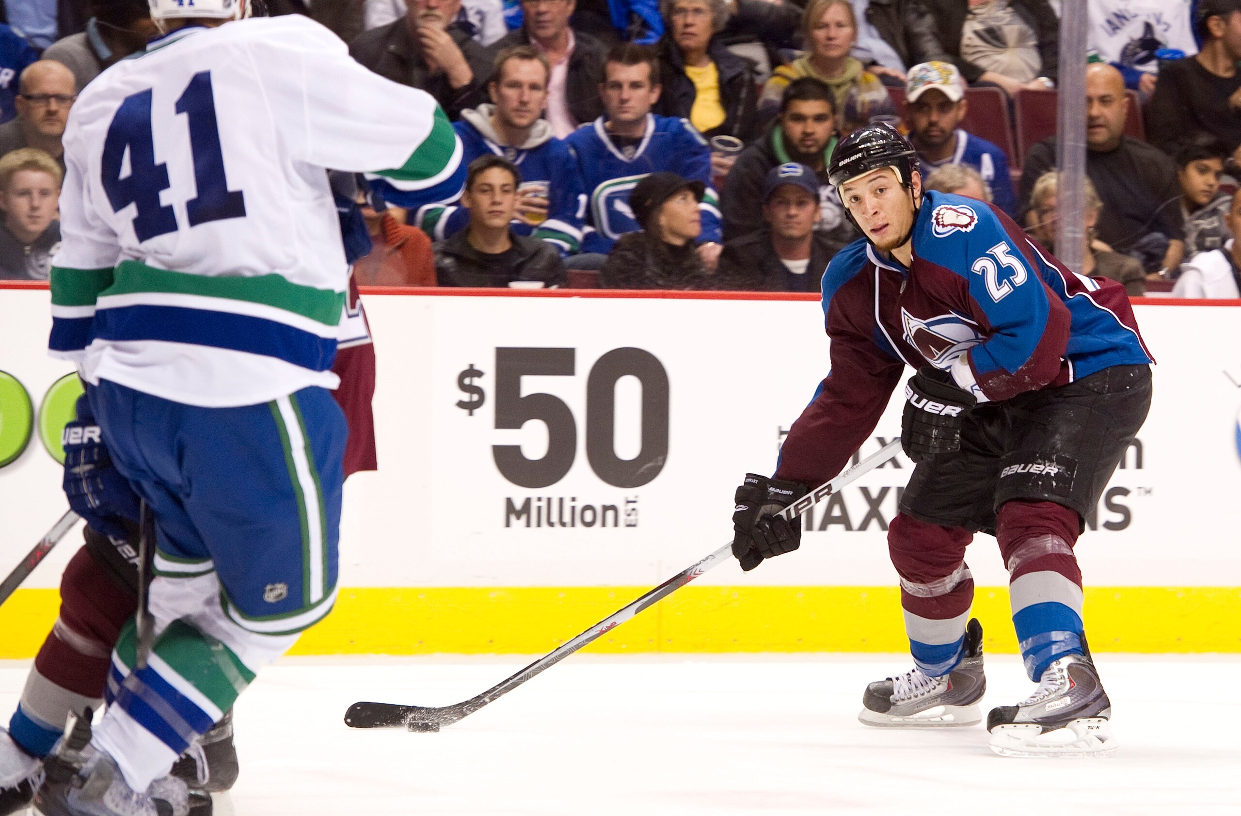 VANCOUVER, CANADA - OCTOBER 26: Chris Stewart #25 of the Colorado Avalanche looks to take a shot on net while Andrew Alberts #41 of the Vancouver Canucks tries to defend on the play during the second period in NHL action on October 26, 2010 at Rogers Aren